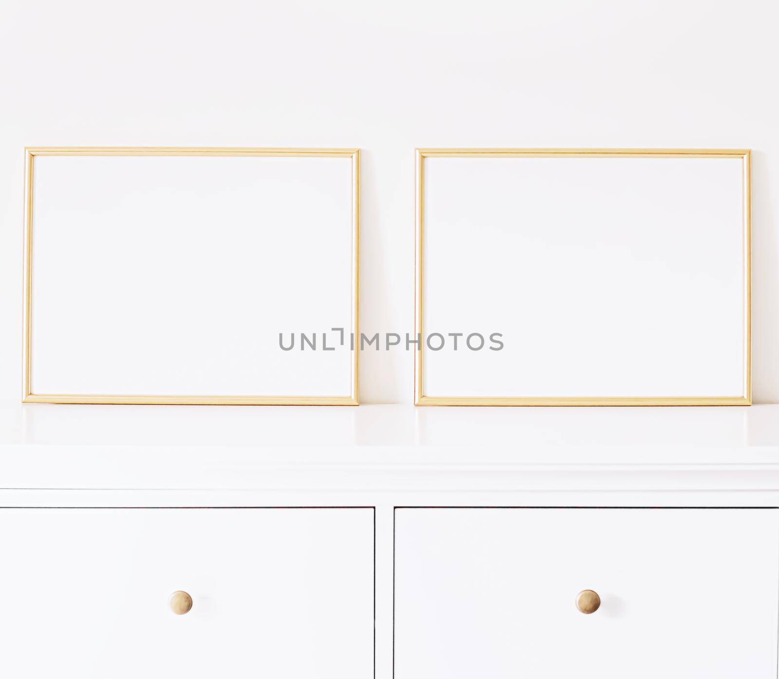 Two golden horizontal frames on white furniture, luxury home decor and design for mockup creations