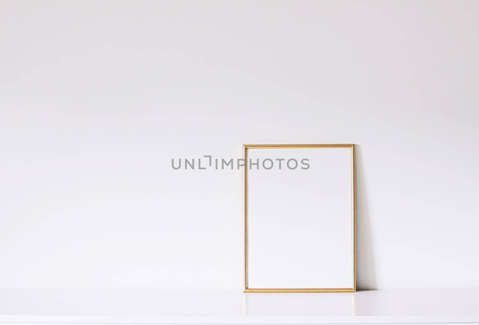 Golden vertical frame on white furniture, luxury home decor and design for mockup creations