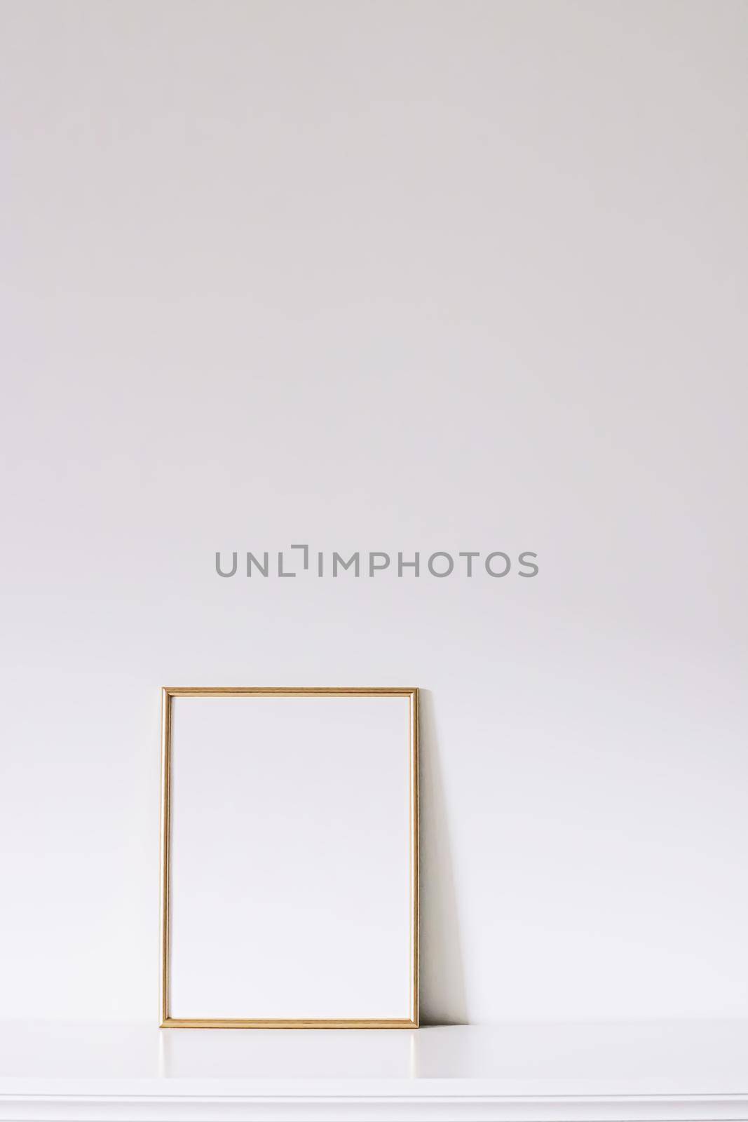 Golden vertical frame on white furniture, luxury home decor and design for mockup creations