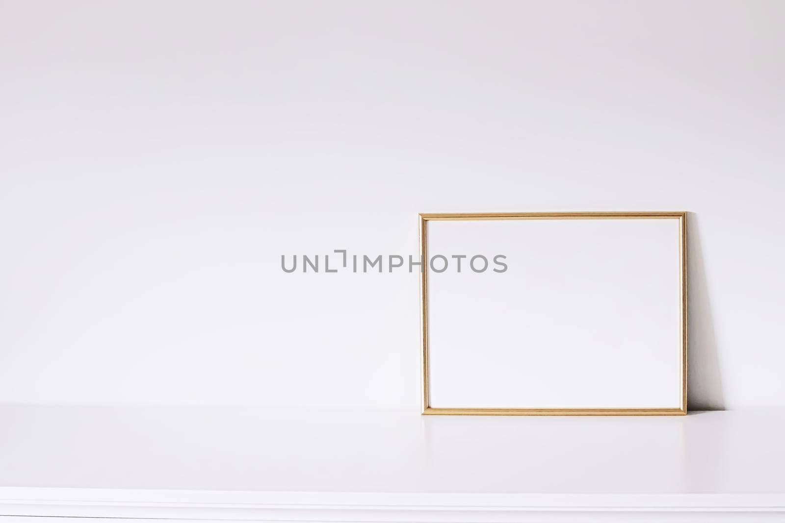 Golden horizontal frame on white furniture, luxury home decor and design for mockup creations