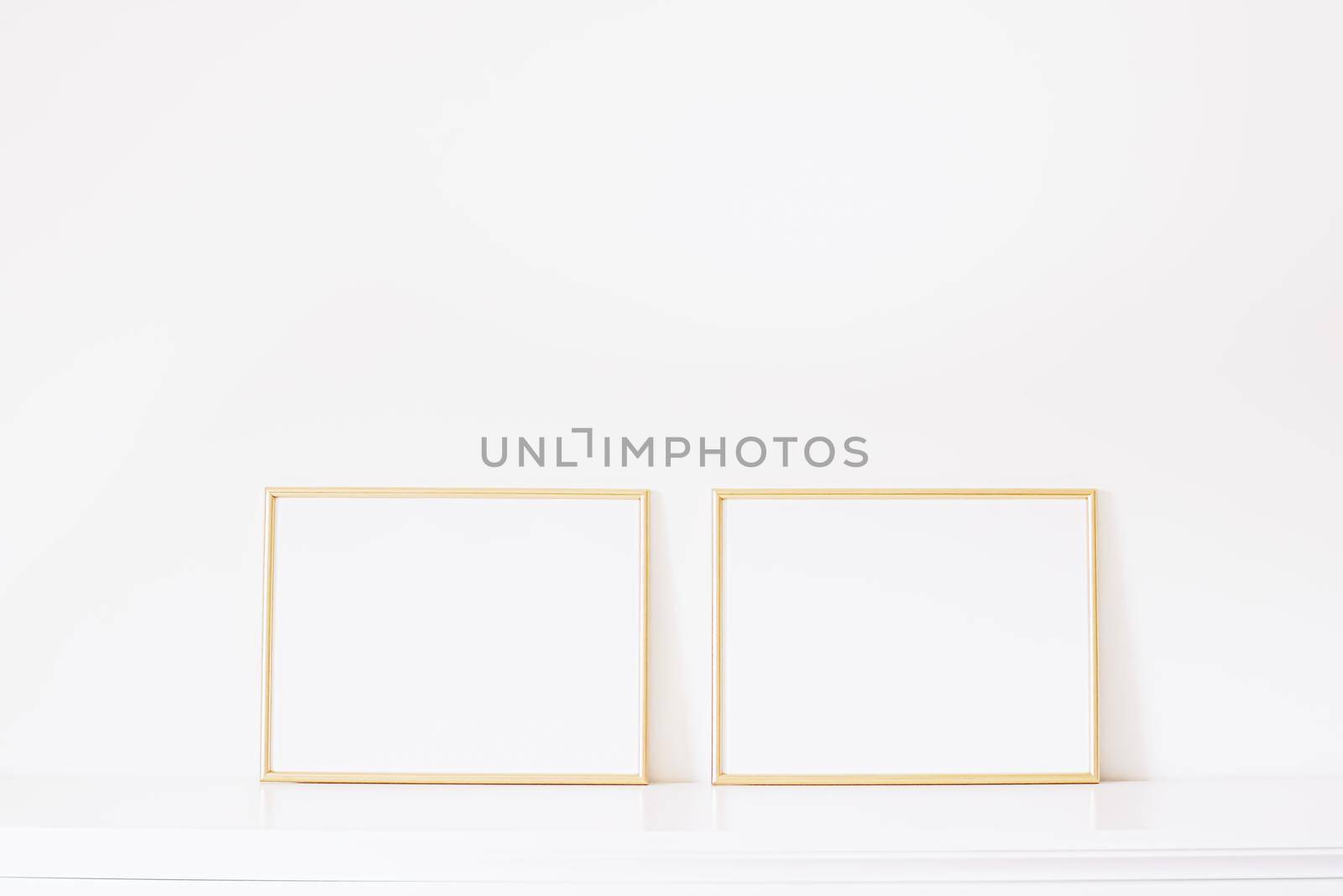 Two golden horizontal frames on white furniture, luxury home decor and design for mockup creations