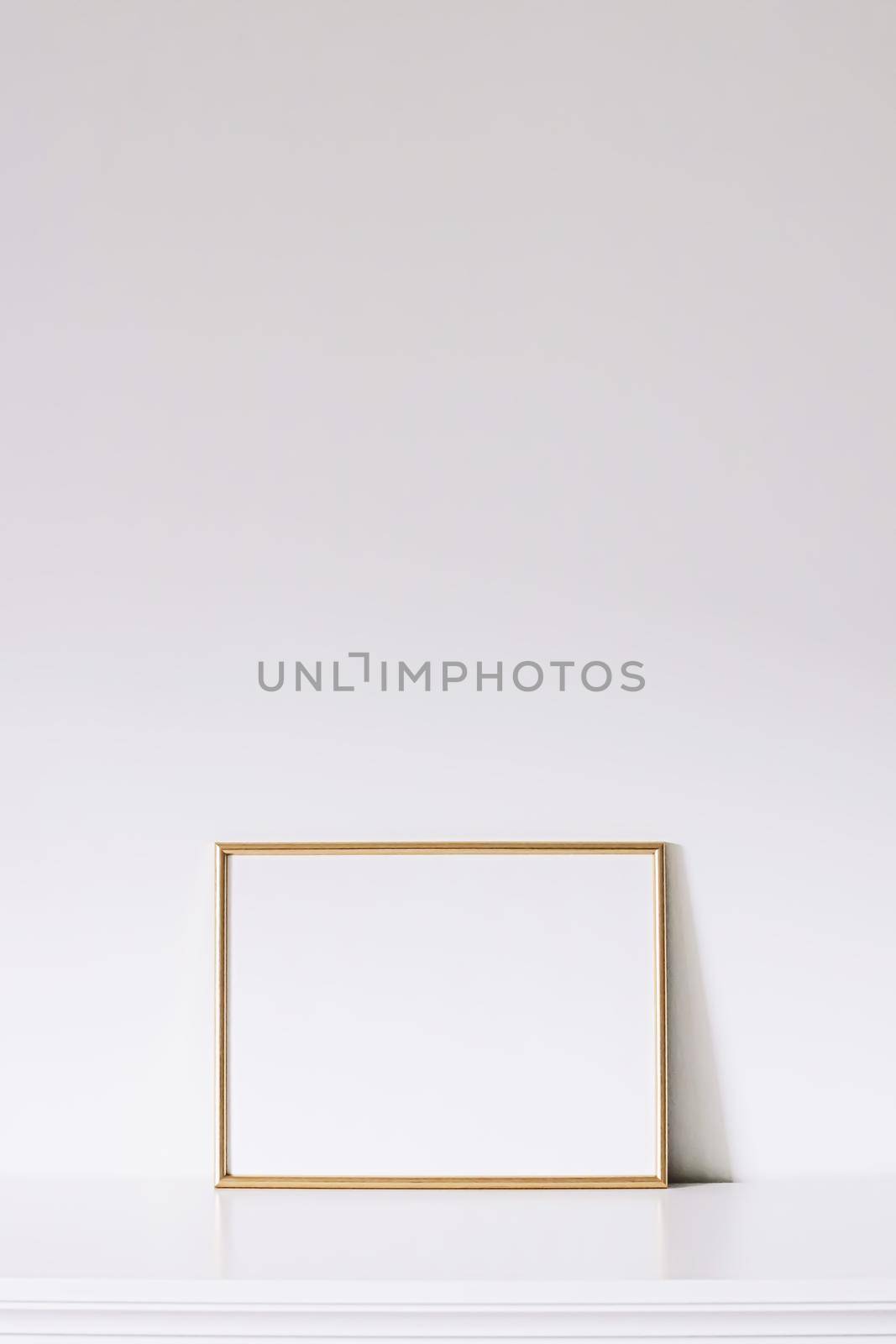 Golden horizontal frame on white furniture, luxury home decor and design for mockup creations