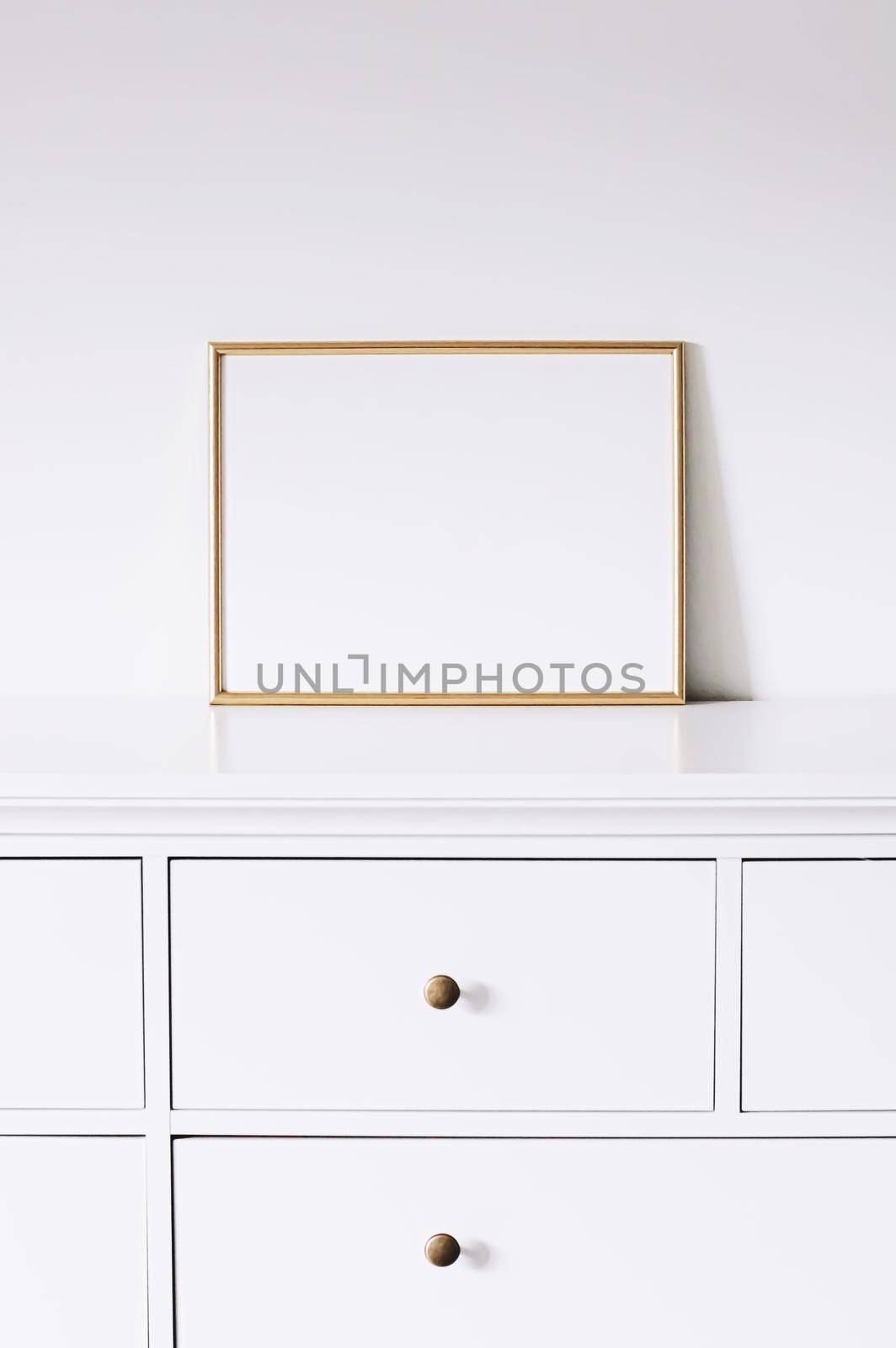 Golden horizontal frame on white furniture, luxury home decor and design for mockup creations