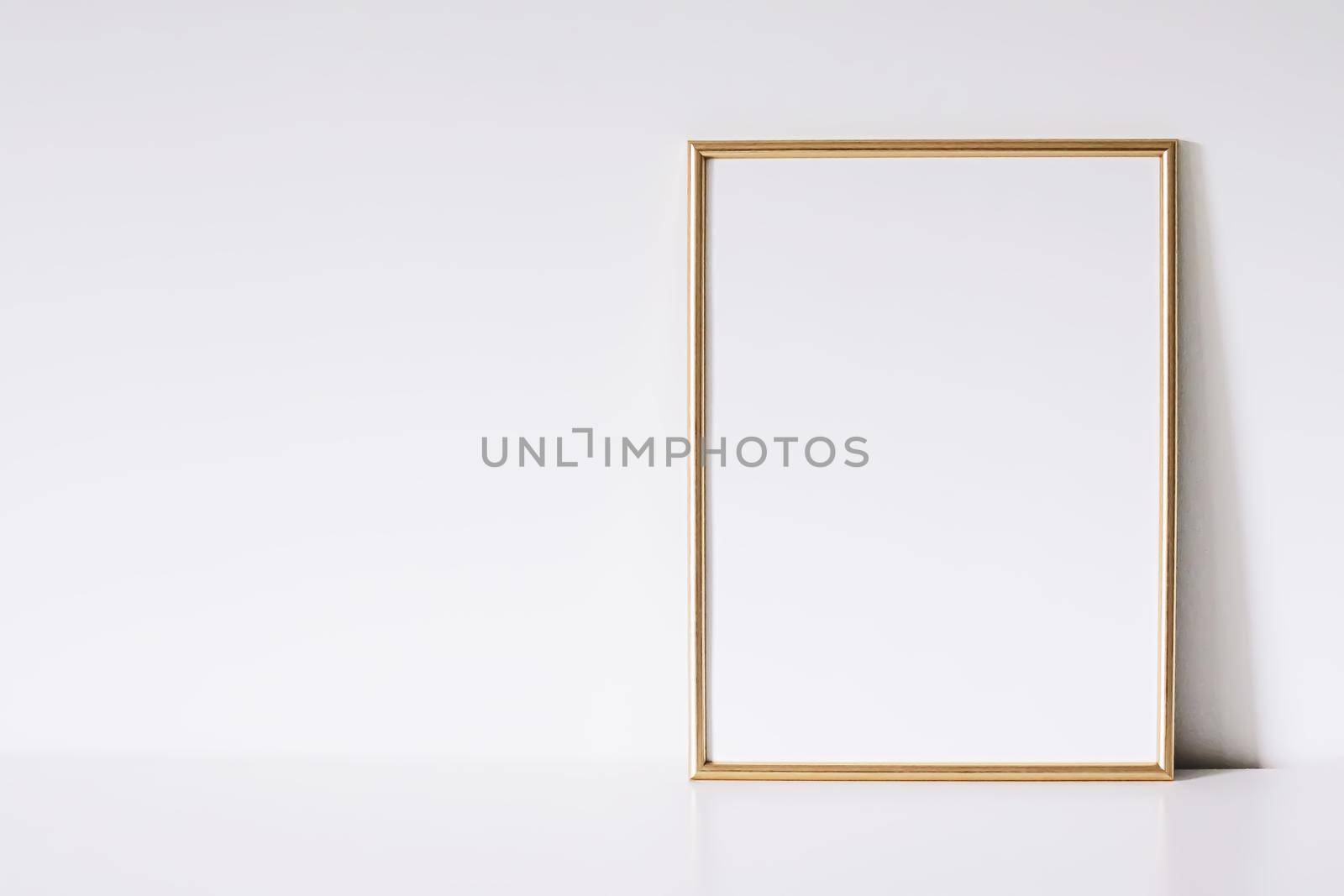 Golden vertical frame on white furniture, luxury home decor and design for mockup creations