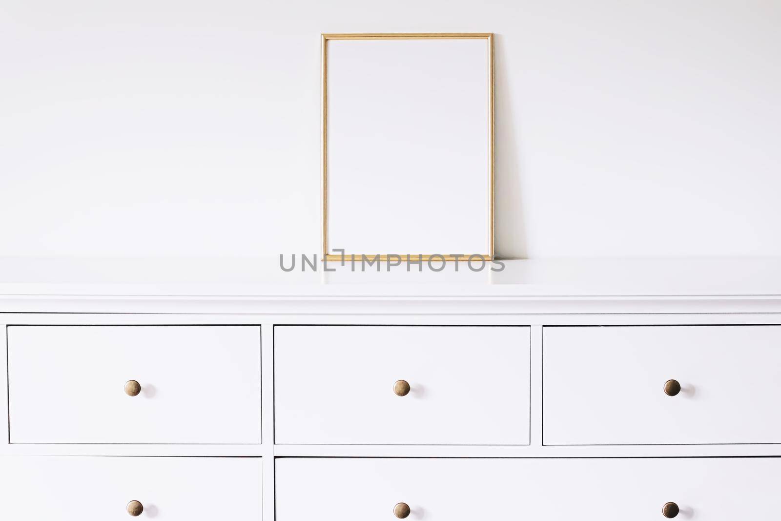 Golden vertical frame on white furniture, luxury home decor and design for mockup creations