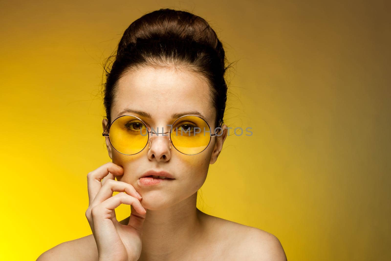 brunette with bare shoulders yellow glasses attractive look passion. High quality photo