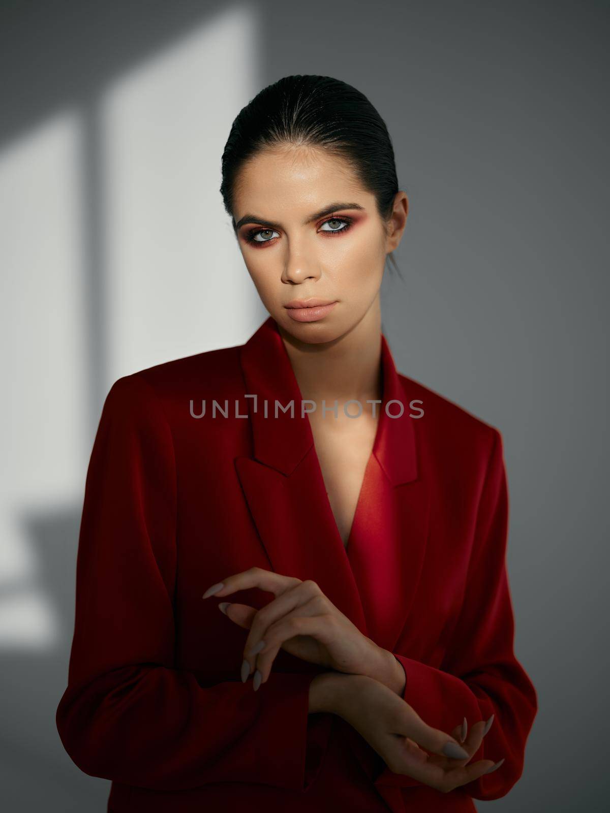 pretty brunette in red blazer modern fashion glamor studio. High quality photo