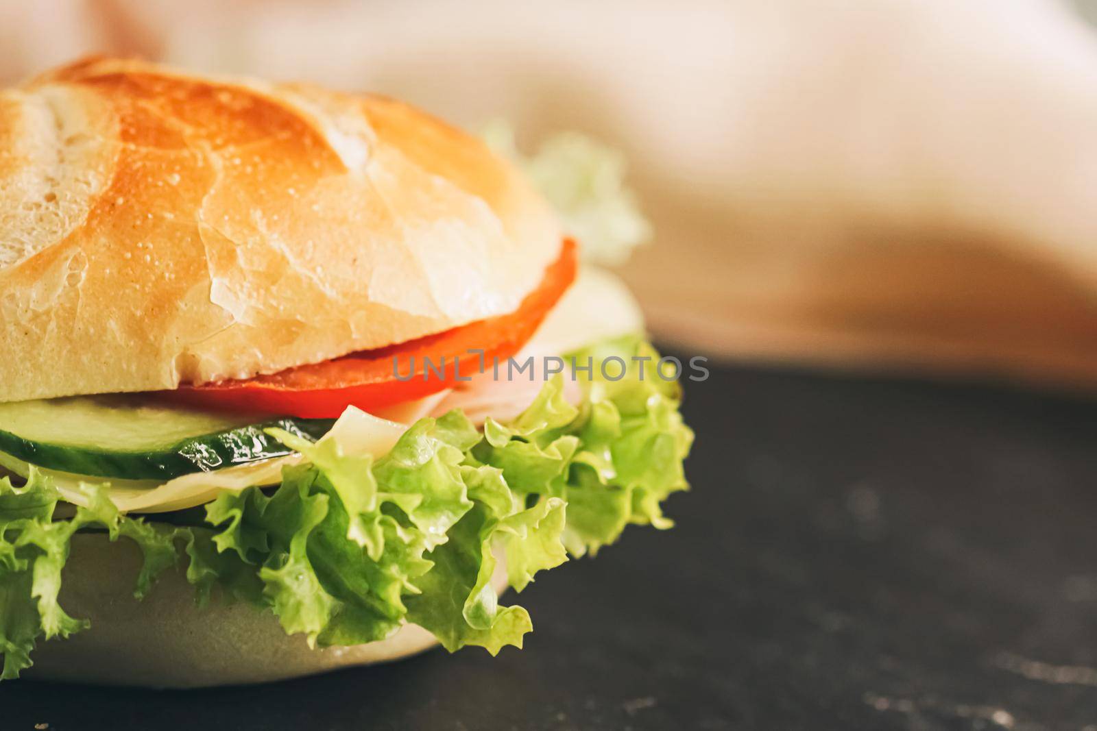 Sandwich with ham, cheese, veggies and lettuce, fast food closeup