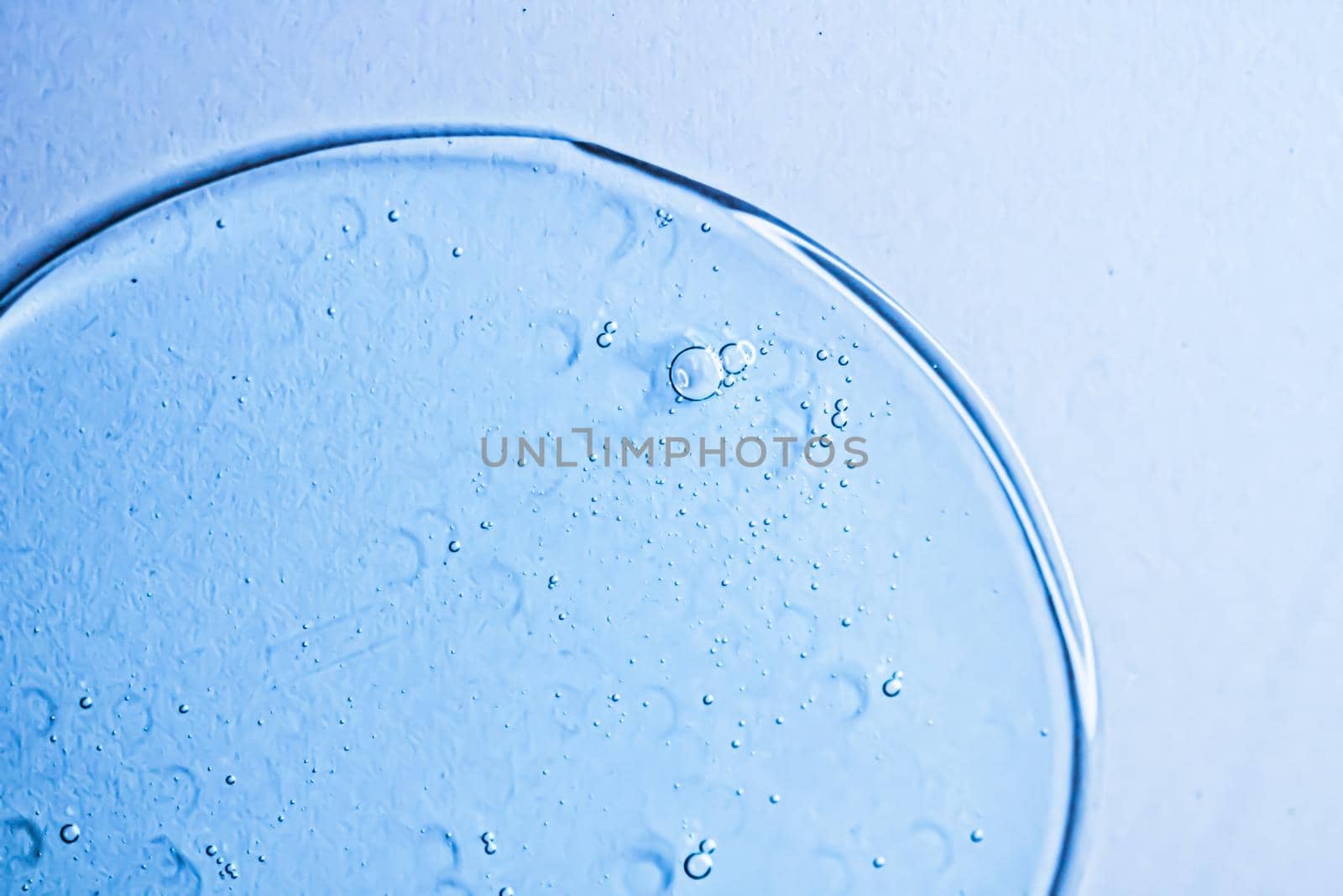 Blue gel texture on glass as cosmetics background, hygiene and science closeup