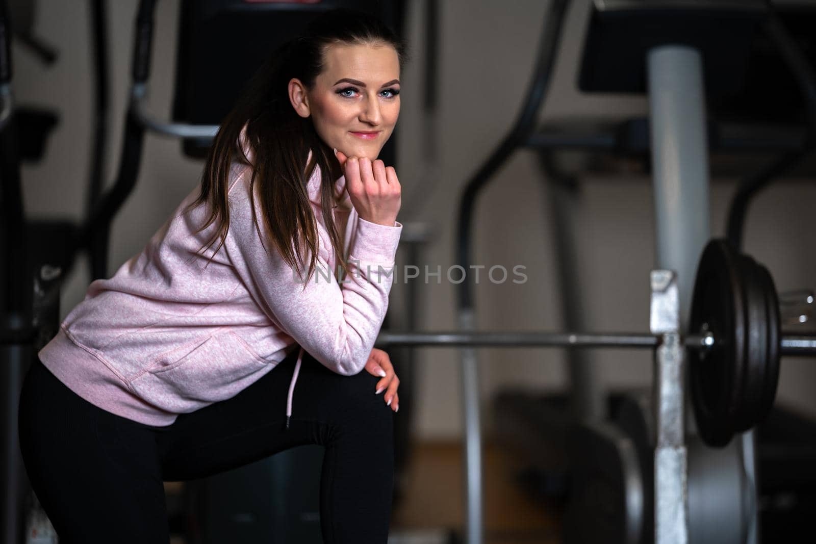 portrait of young beautiful woman fitness instructor in gym.