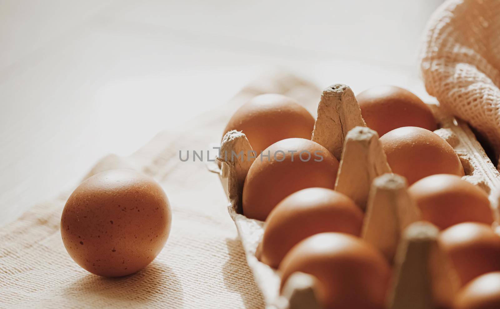 organic farm eggs in egg box and rustic cloth napkins by Anneleven