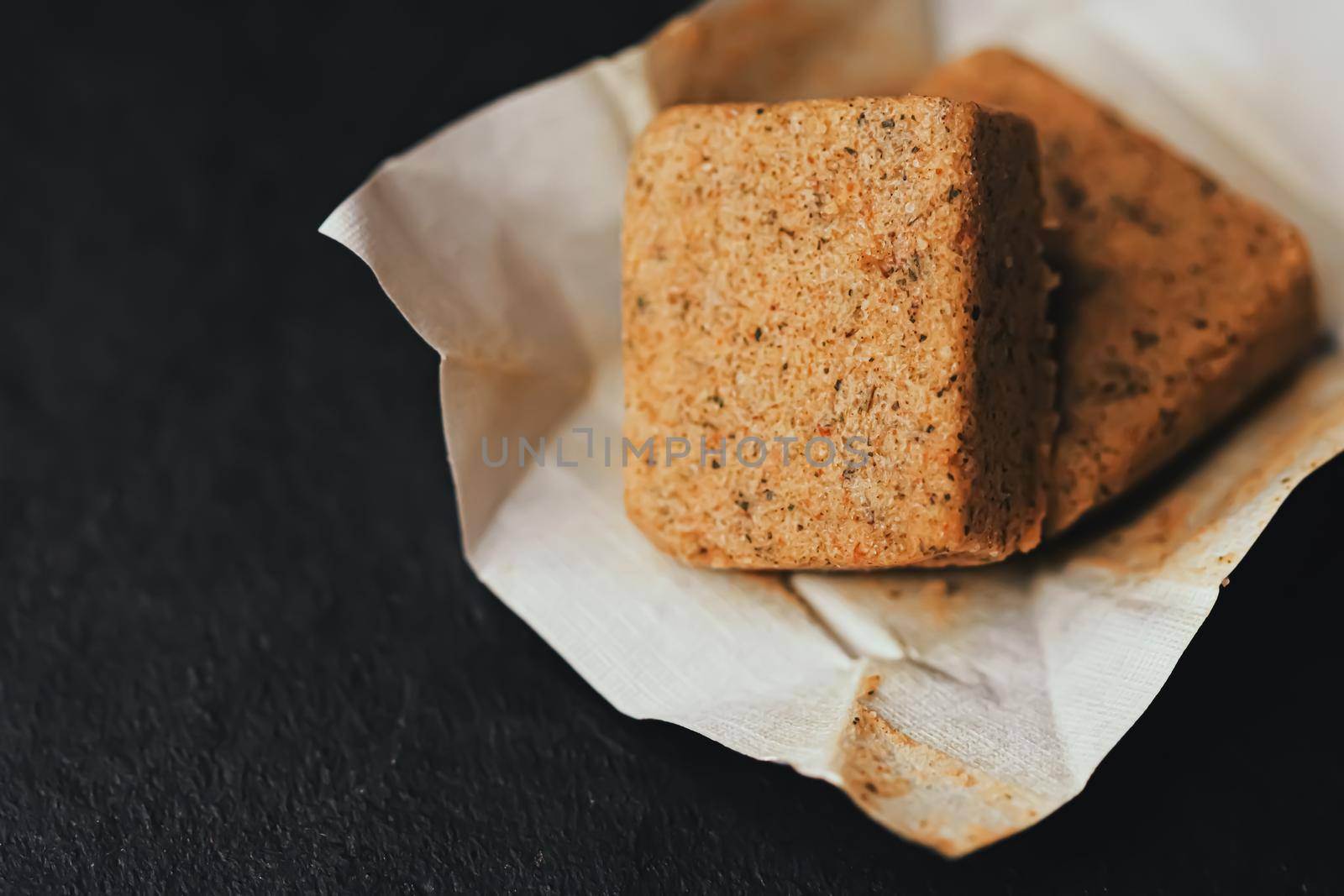 Vegetable bouillon cubes on stone kitchen board, stock or broth ingredient for soup by Anneleven