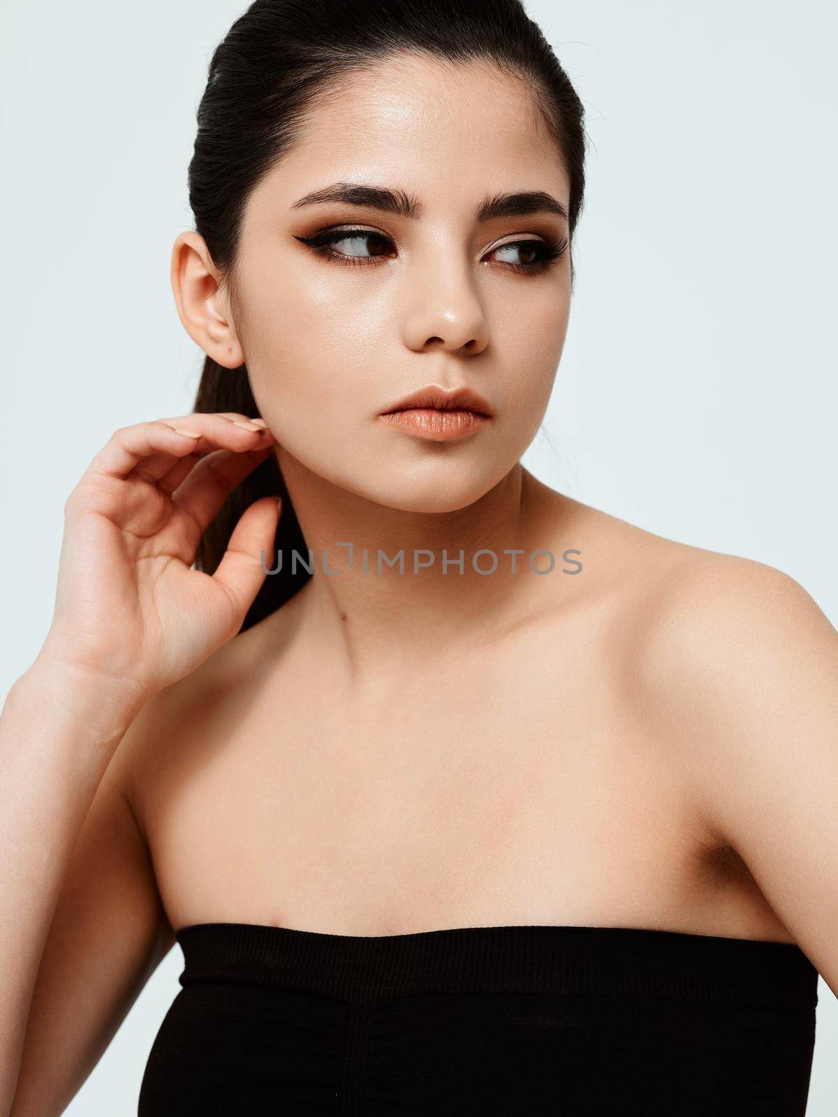 pretty brunette in black dress with evening makeup on her face by SHOTPRIME