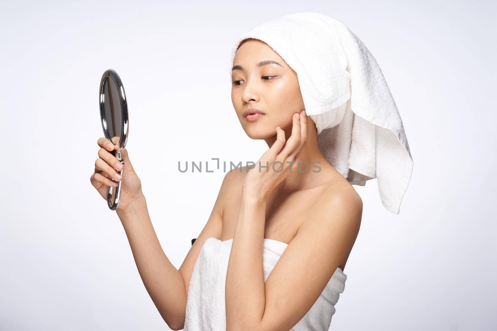 pretty woman looking in the mirror clean skin after shower. High quality photo