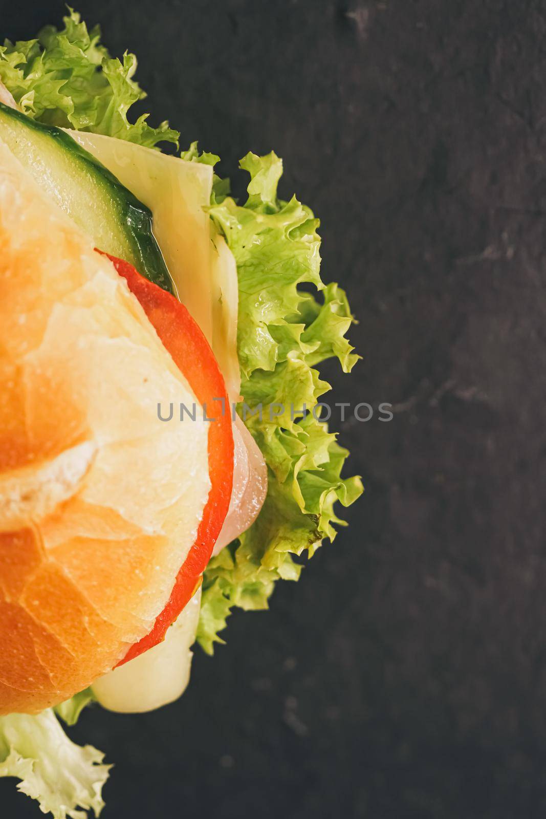 Sandwich with ham, cheese, veggies and lettuce, fast food closeup