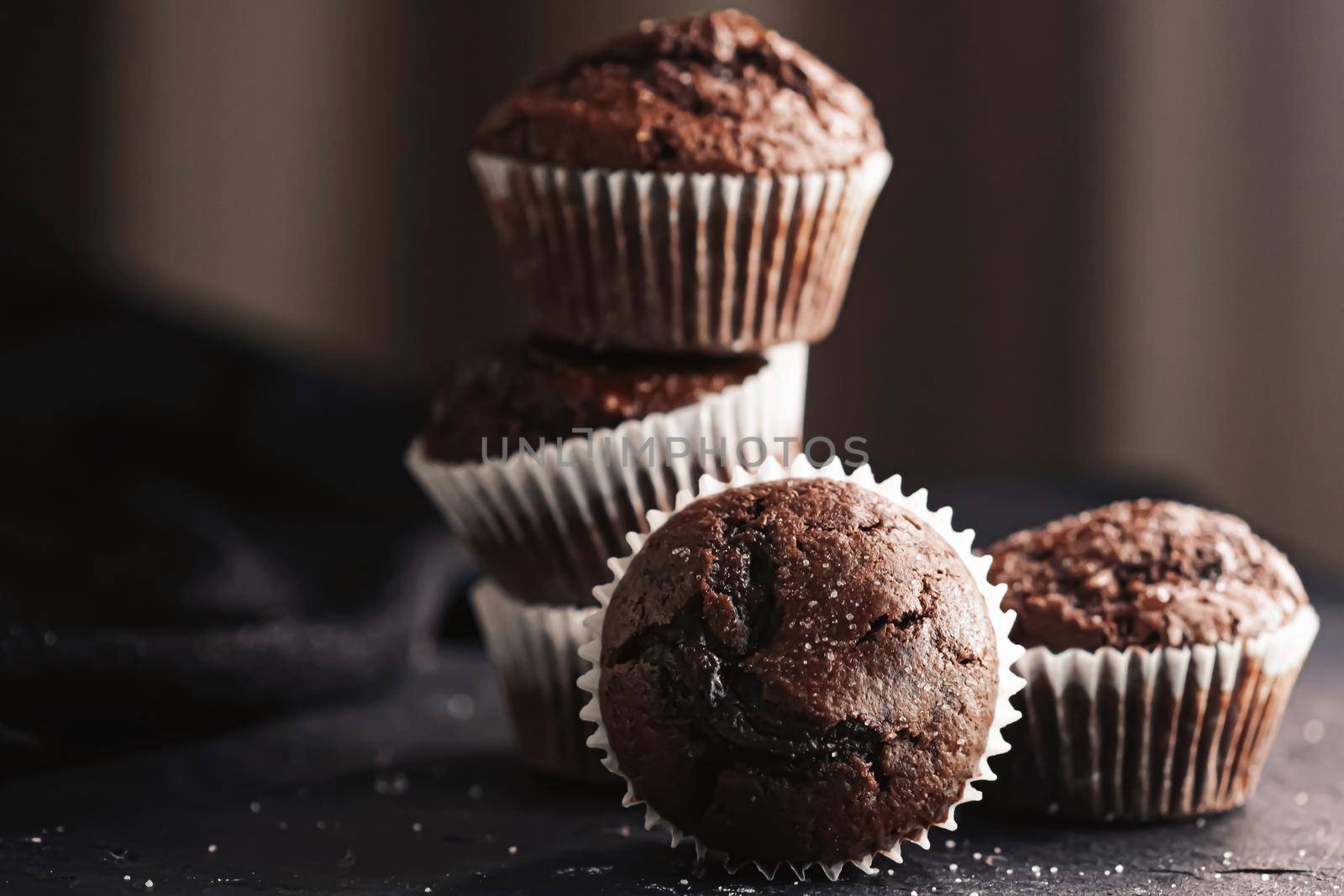 Homemade chocolate muffins, baked comfort food recipe concept