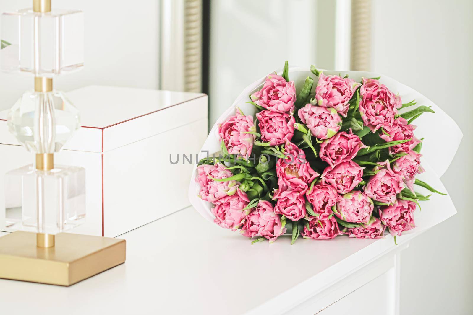 Bouquet of fresh cut pink tulips in an elegant interior, home decor by Anneleven