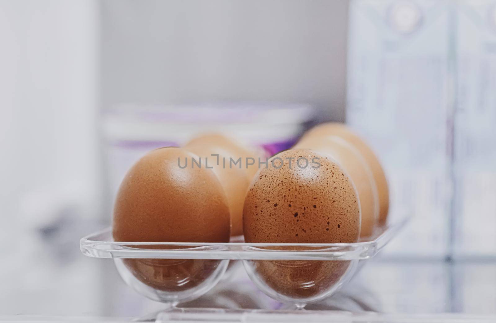 fresh eggs in refrigerator, dairy product closeup