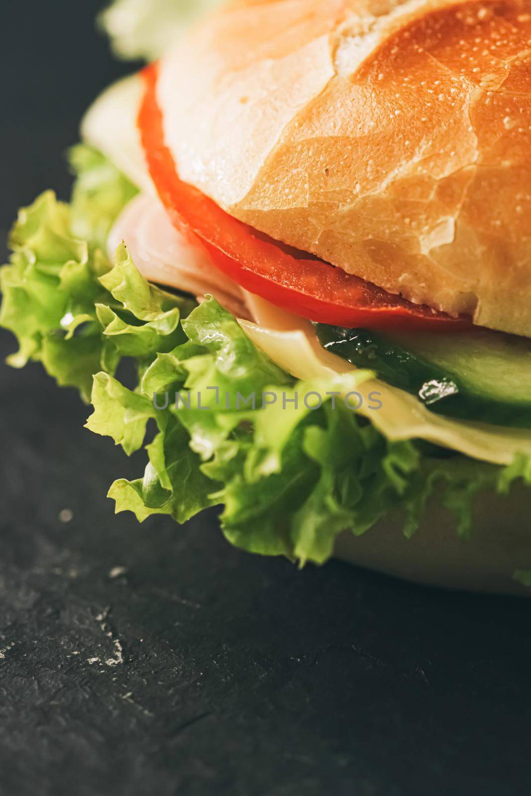 Sandwich with ham, cheese, veggies and lettuce, fast food closeup