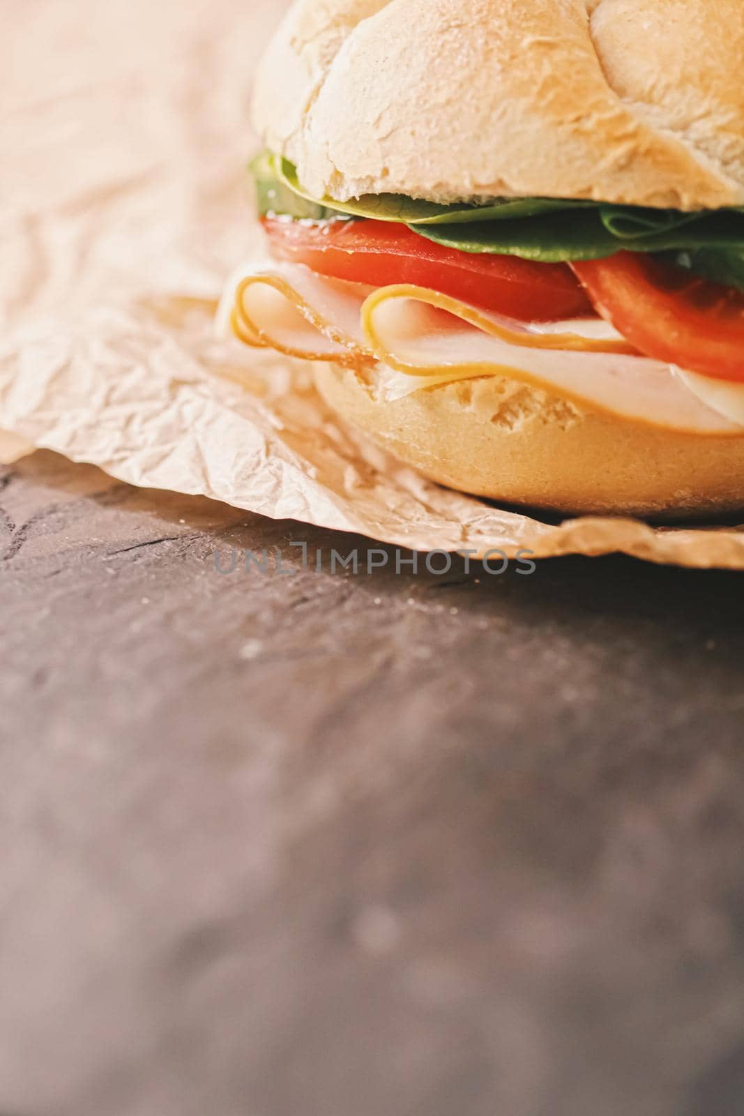 Sandwich with ham, cheese and fresh greens, take out comfort food closeup