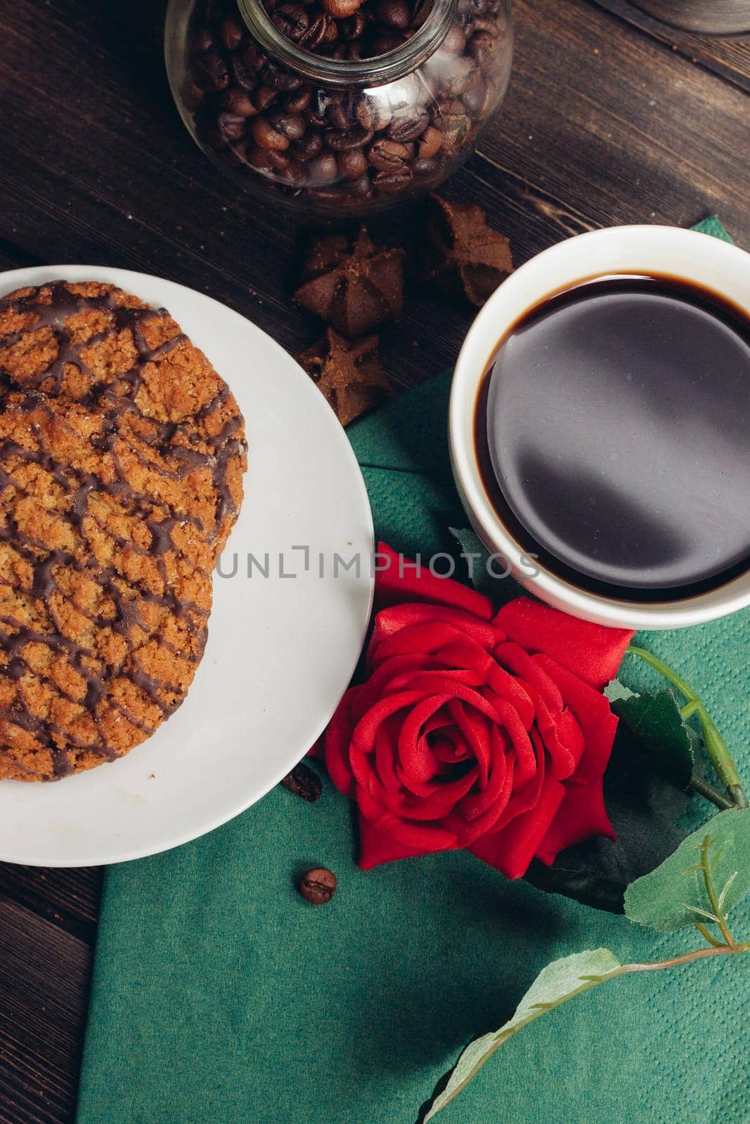 sweet biscuits plates green napkin wooden table coffee. High quality photo