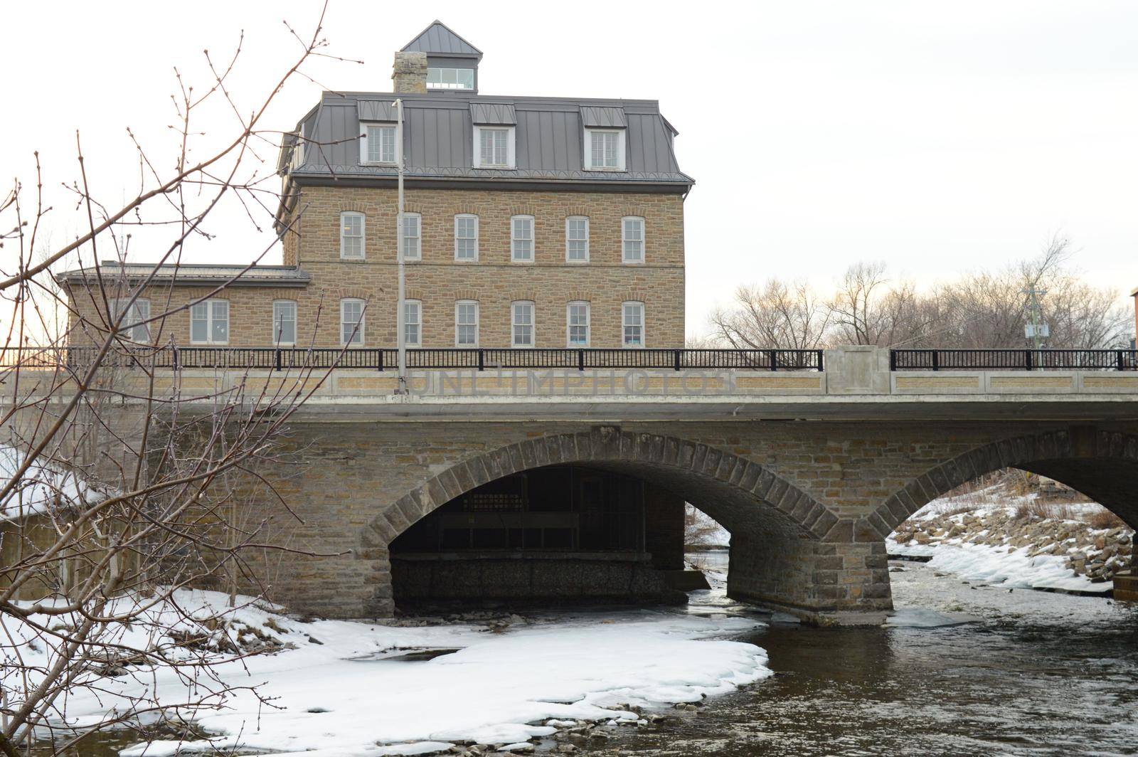 SMITHS FALLS, ONTARIO, CANADA, MARCH 10, 2021: A view of the Rideau Canal Museum and Beckwith St Bridge from across the waterway on a late winters day in small town Smiths Falls, ON.