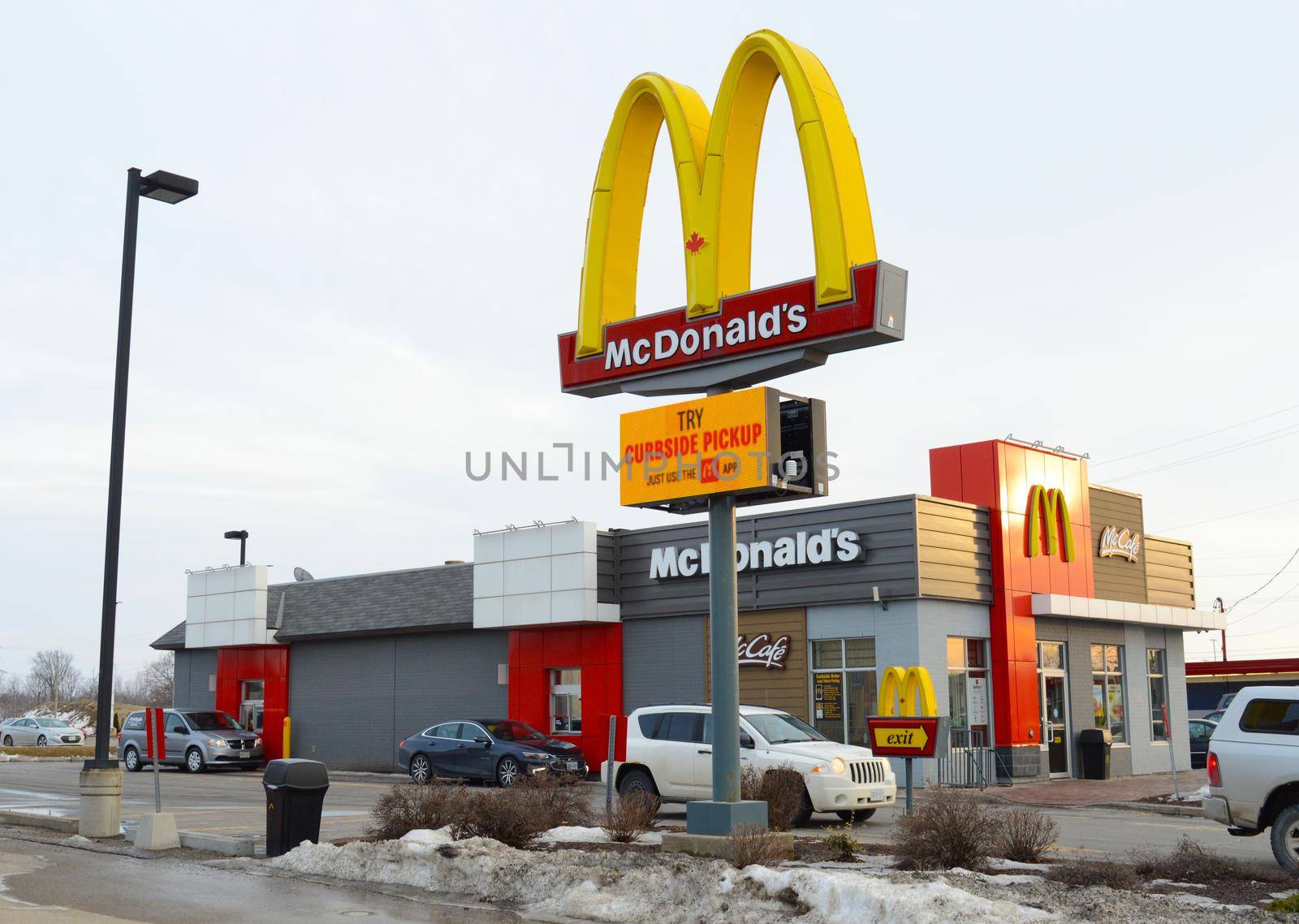 SMITHS FALLS, ONTARIO, CANADA, MARCH 10, 2021: The exterior view of a McDonalds restaurant located in the small town of Smiths Falls, ON, during the late winter season.