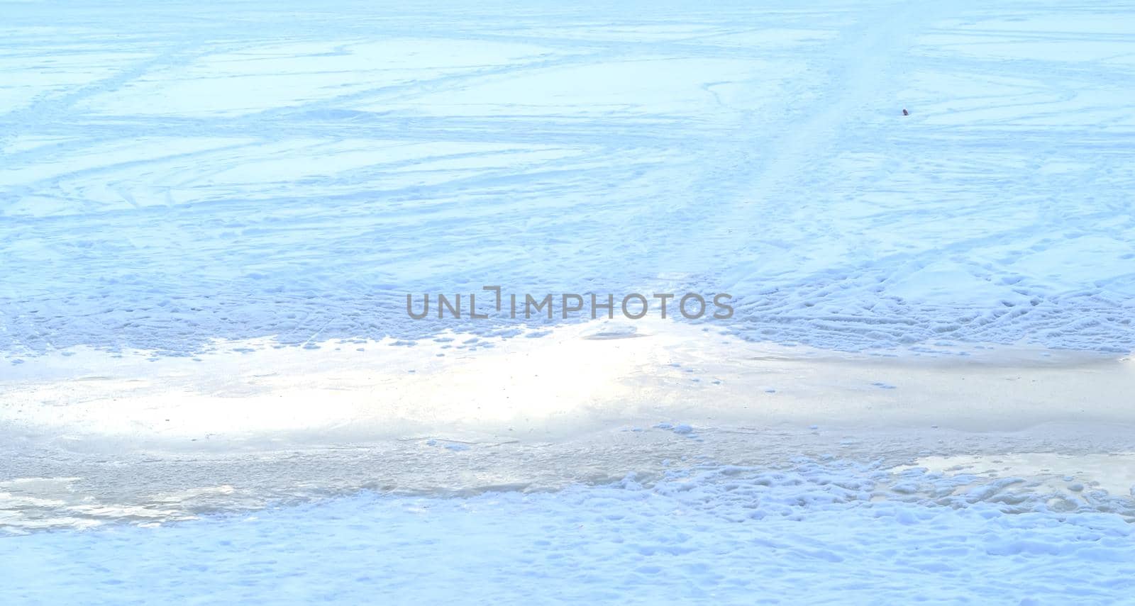 Abstract winter background.Frozen river on a sunny winter day