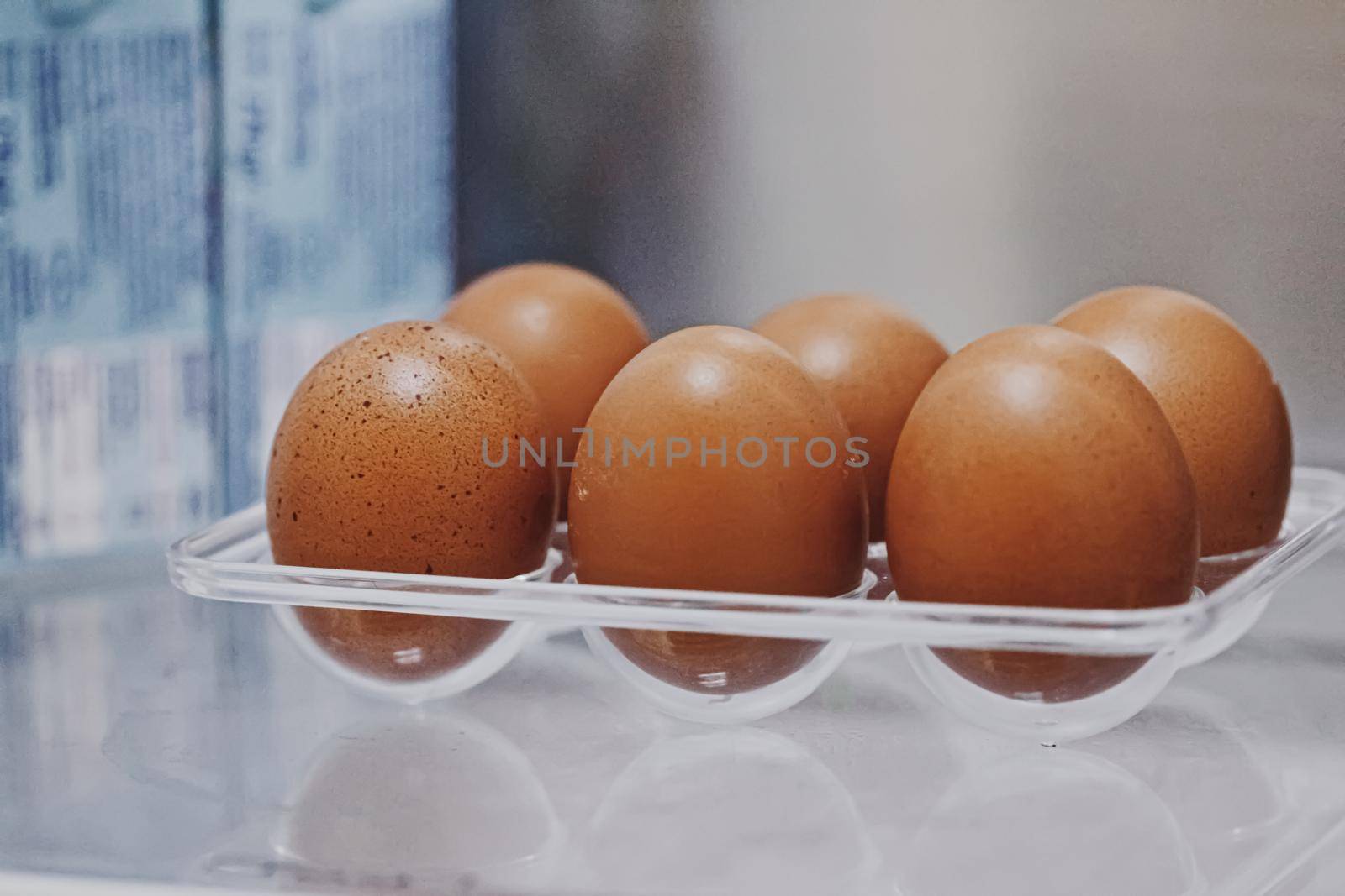 fresh eggs in refrigerator, dairy product closeup