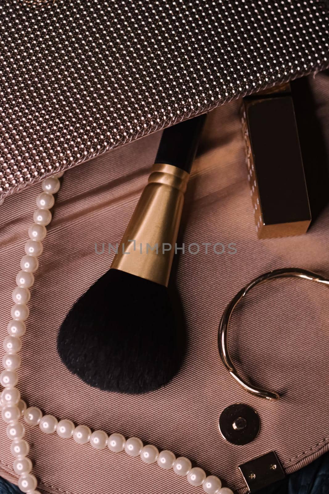 Jewellery and makeup tools inside a womans purse, beauty and fashion by Anneleven