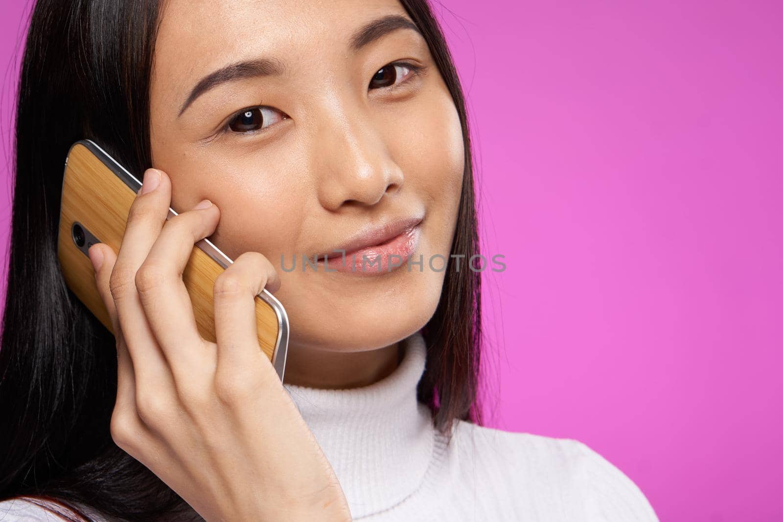 woman asian appearance phone close-up smile pink technology background by SHOTPRIME