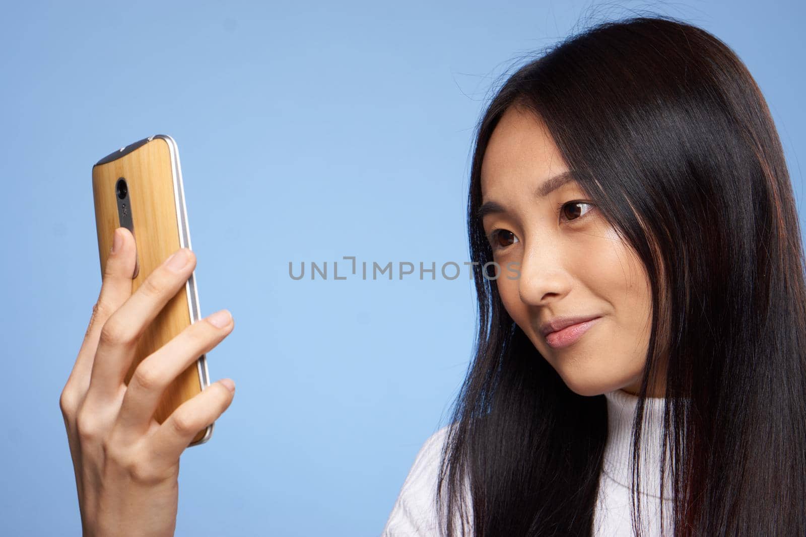 pretty brunette phone in hands communication device technology. High quality photo