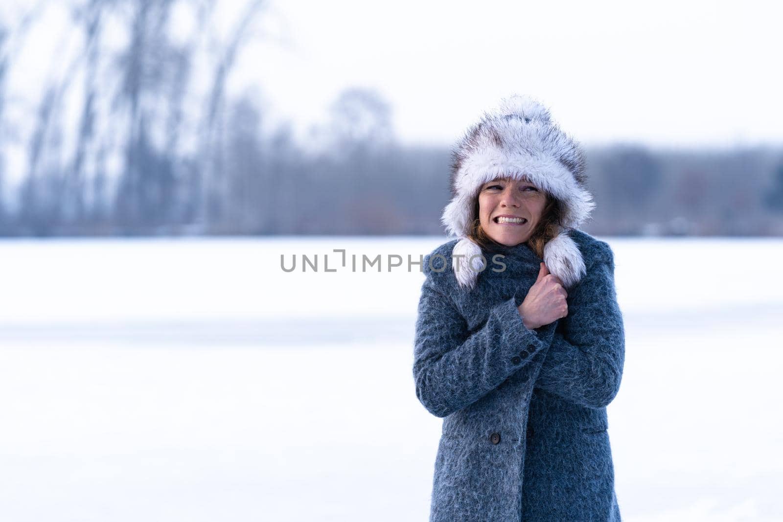 young freezing woman on winter icy lake by Edophoto