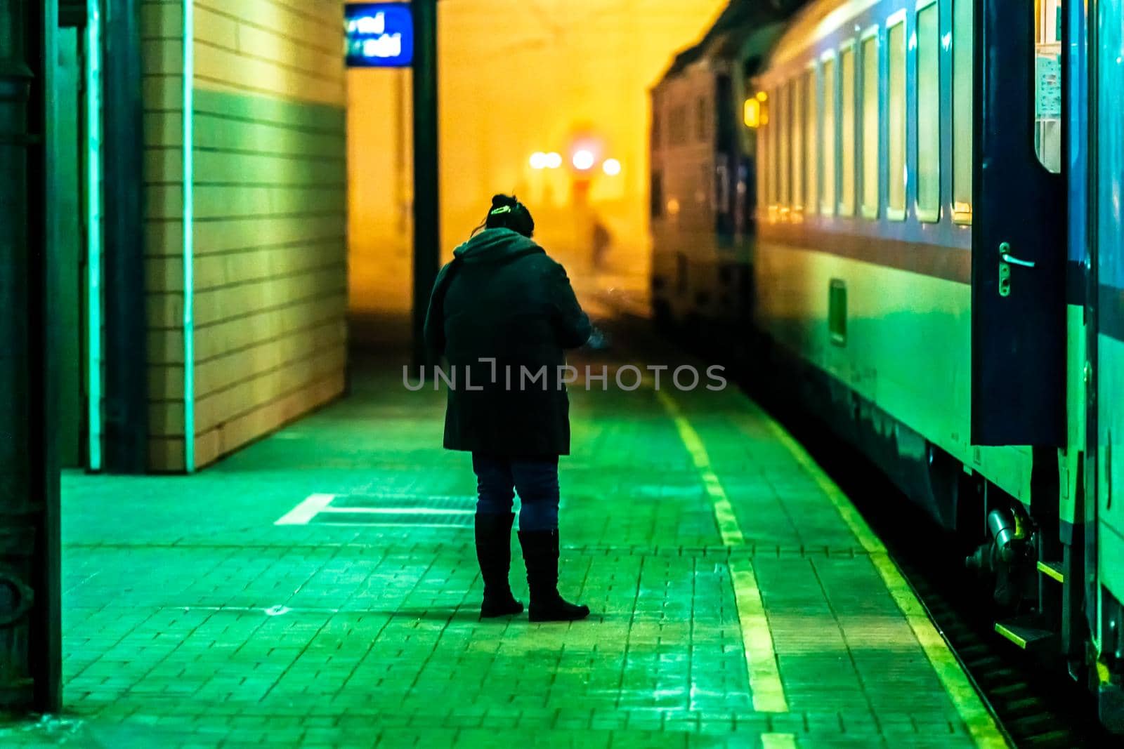 woman boarding a night train at the station by Edophoto