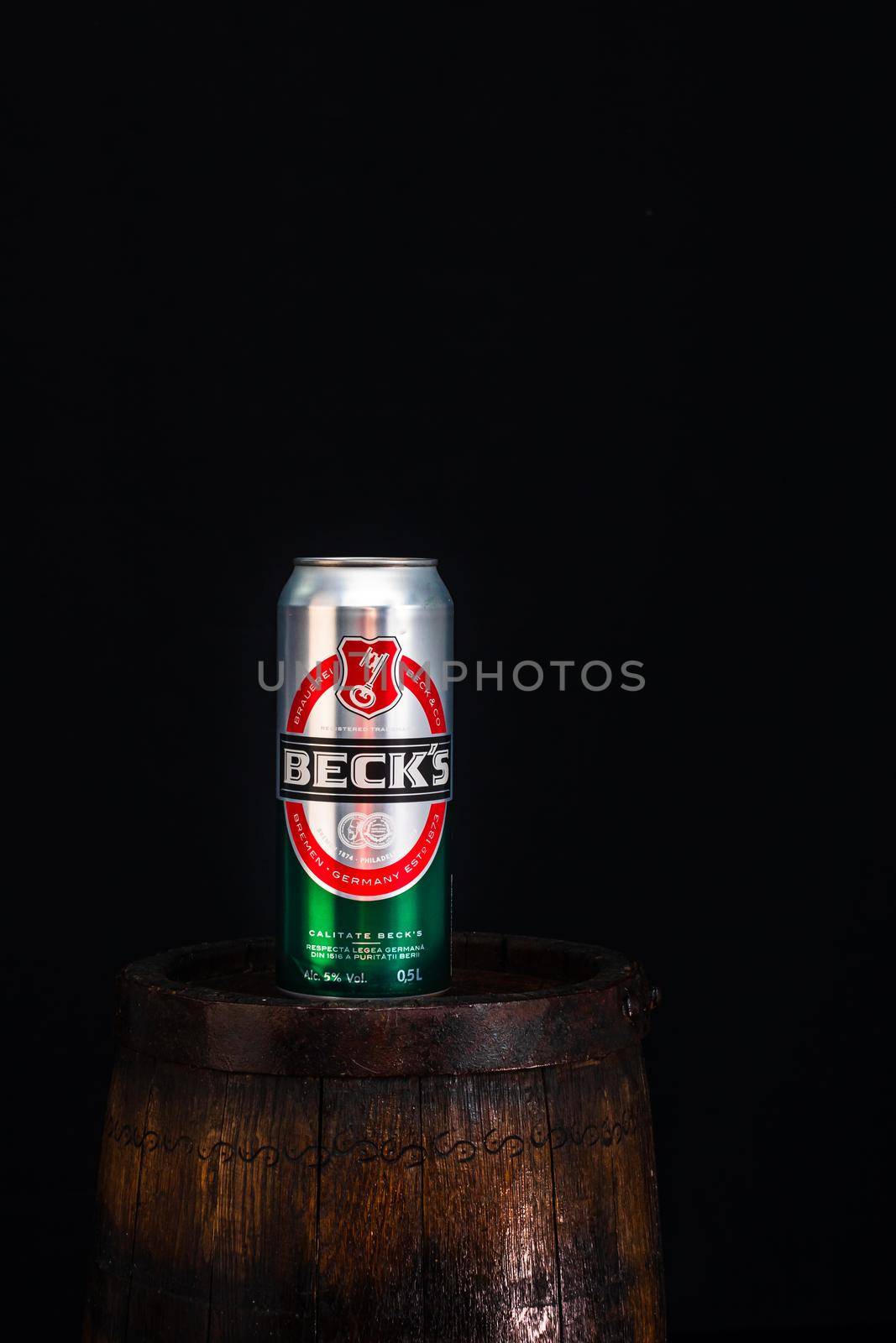 Can of Becks beer on beer barrel with dark background. Illustrative editorial photo Bucharest, Romania, 2021 by vladispas