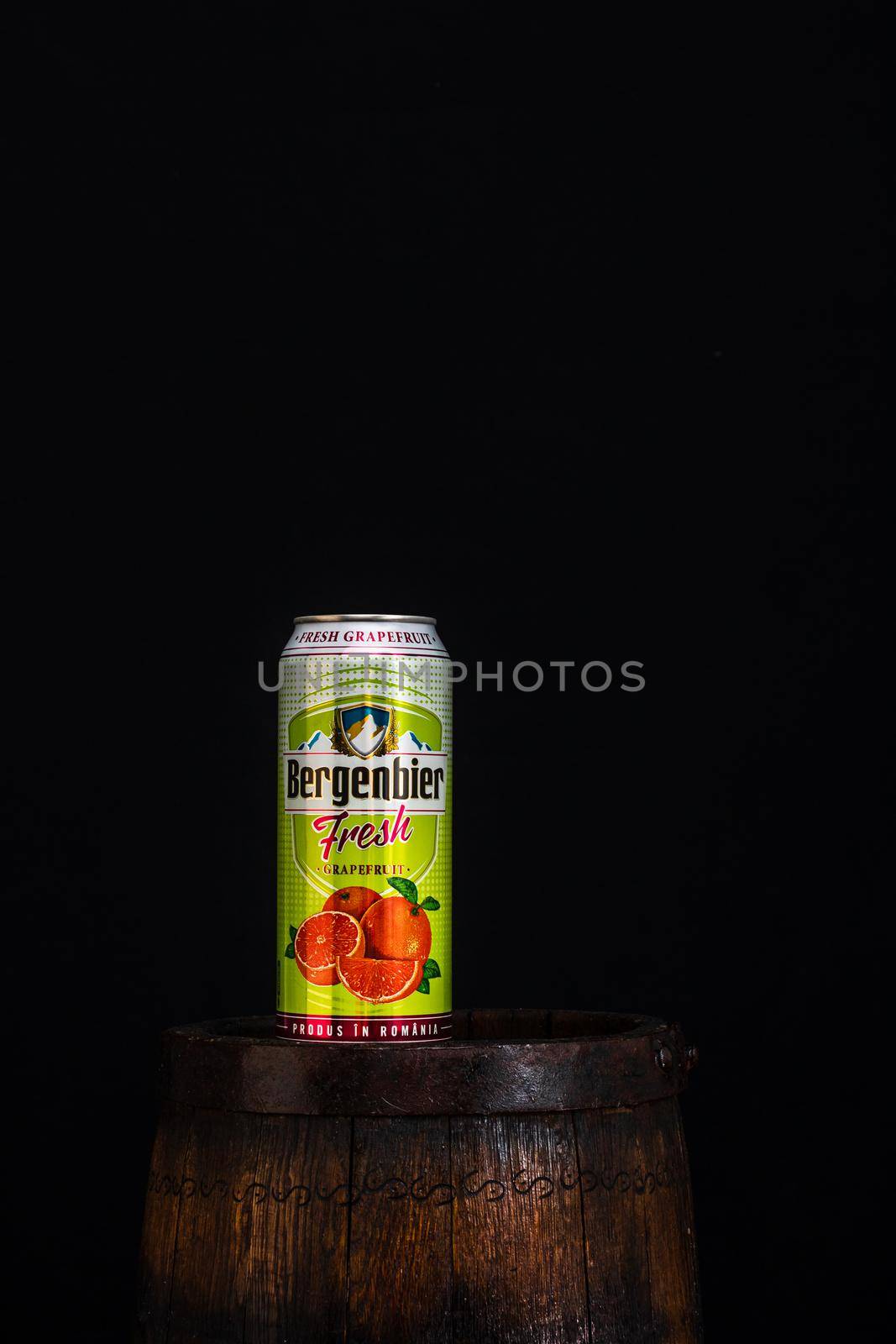 Can of Bergenbier beer on beer barrel with dark background. Illustrative editorial photo Bucharest, Romania, 2021 by vladispas