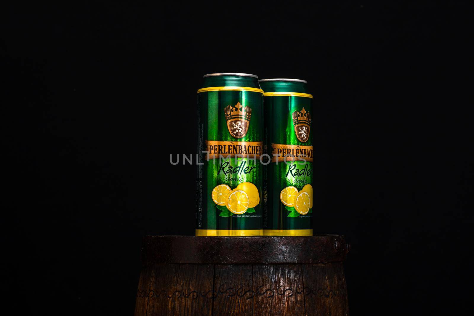 Can of Perlenbacher Radler beer on beer barrel with dark background. Illustrative editorial photo shot in Bucharest, Romania, 2021