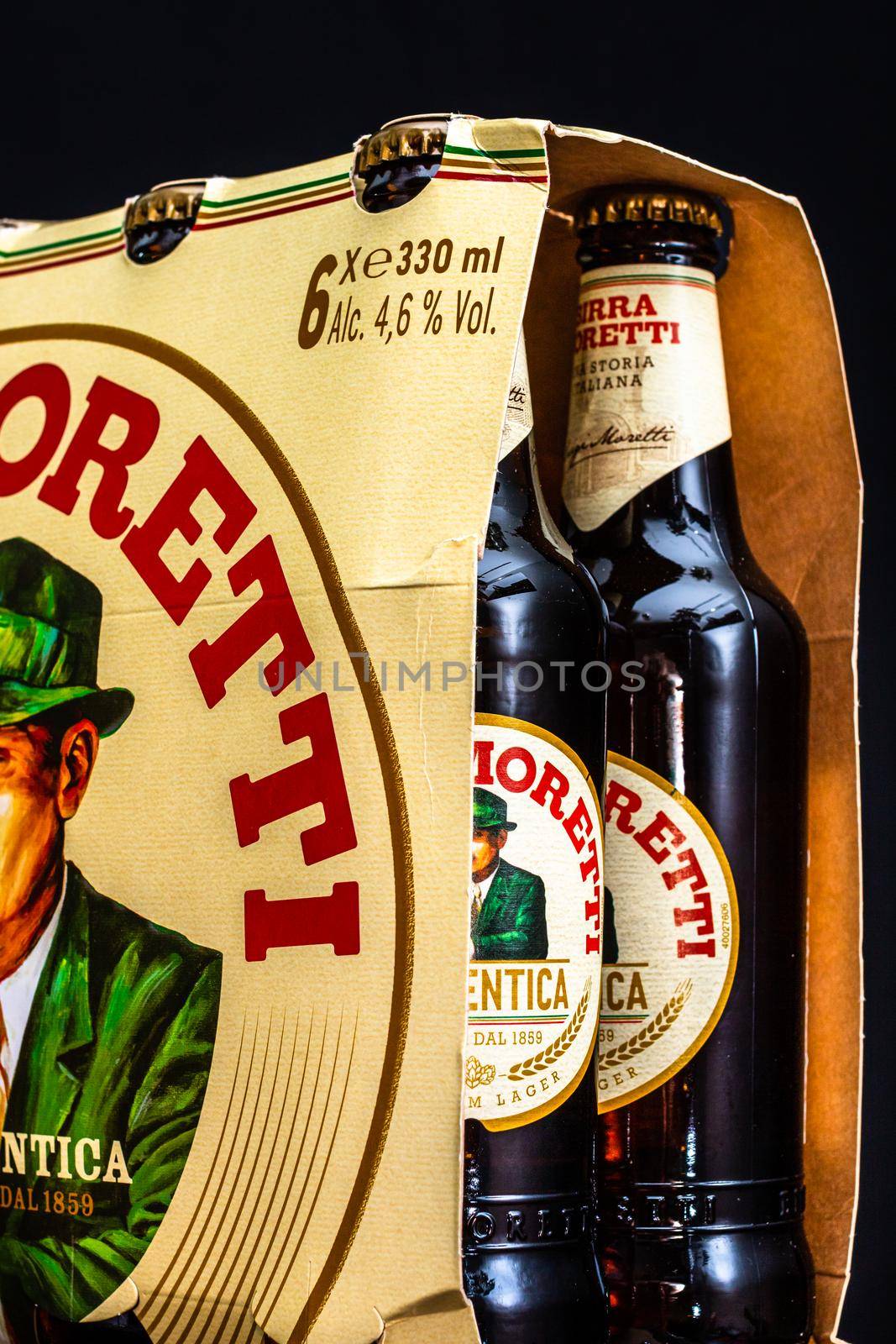 6 pack of Birra Moretti beer on wooden barrel with dark background. Illustrative editorial photo Bucharest, Romania, 2021 by vladispas