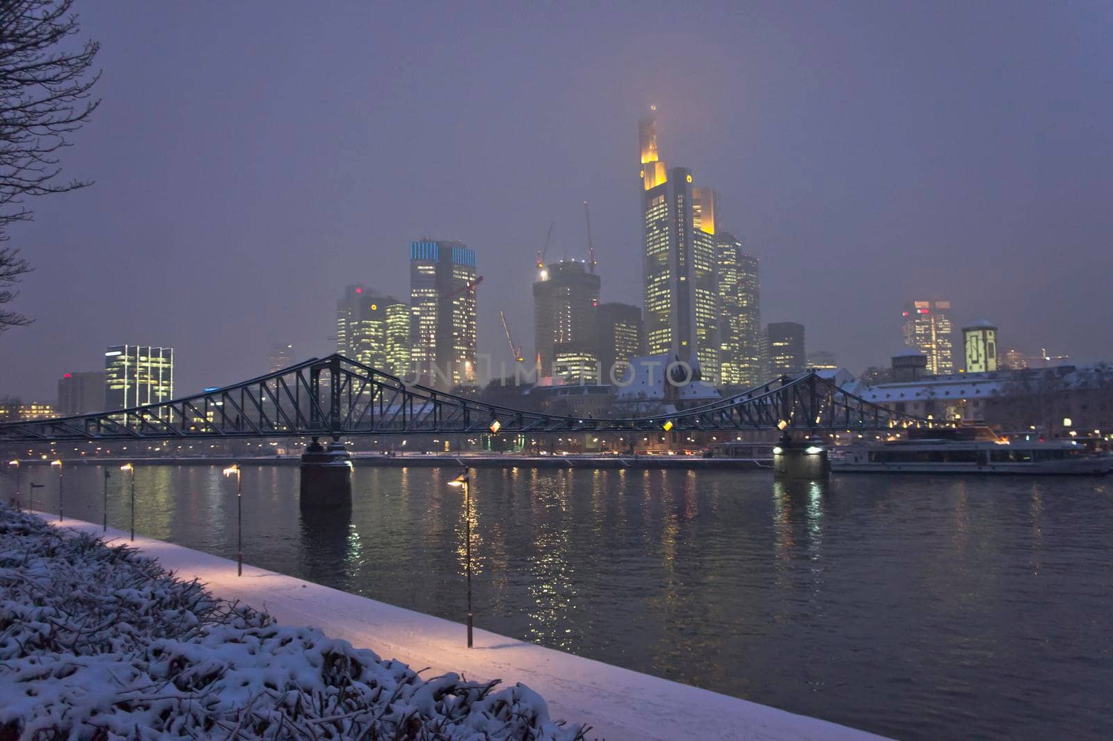 Frankfurt, Snowy night city view by the river Rhein, Germany, Europe