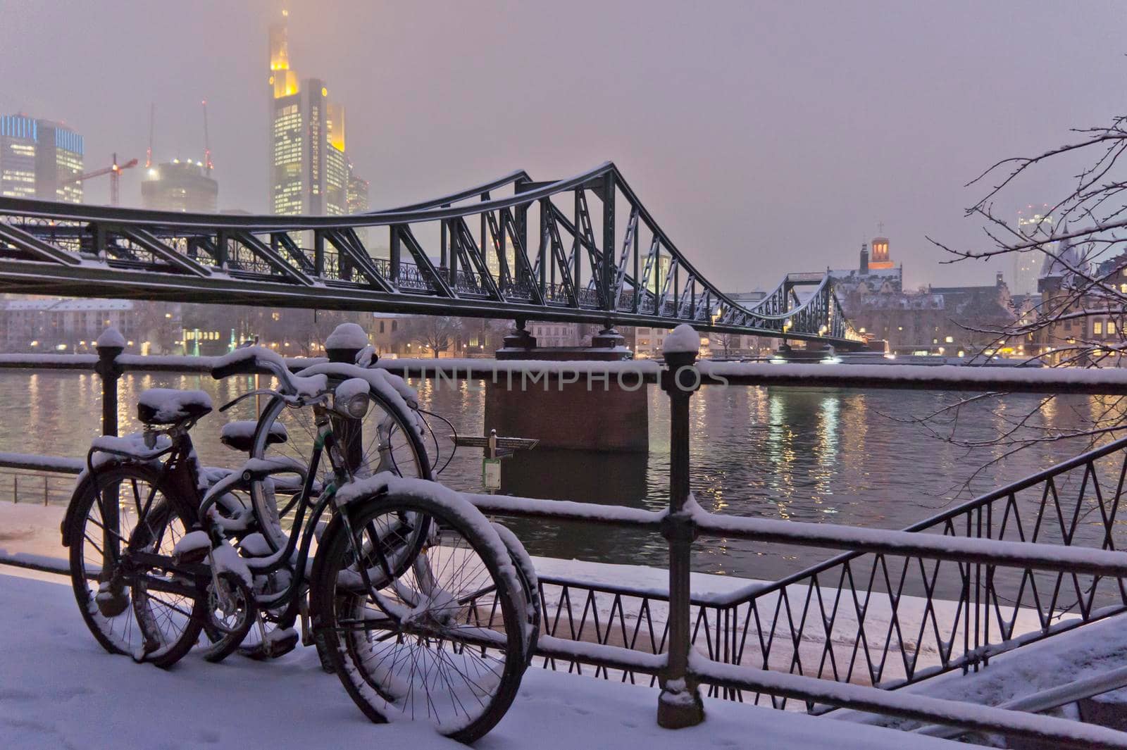 Frankfurt, Snowy night city view by the river Rhein, Snowy Bicycles, Germany, Europe