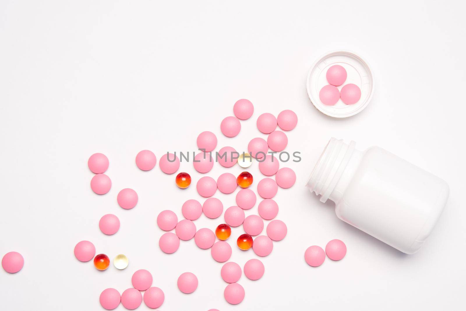 White jar with pills on a light background top view medicine health vitamins. High quality photo