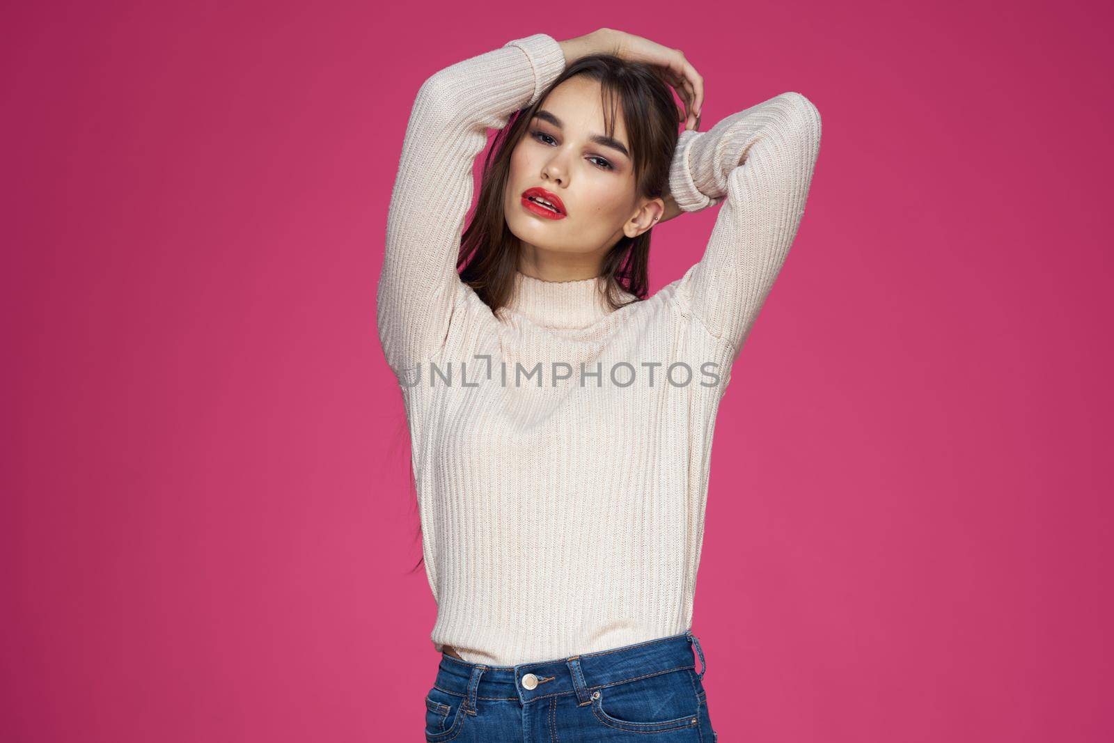 Beautiful brunette long hair fashionable clothes elegant style pink background. High quality photo
