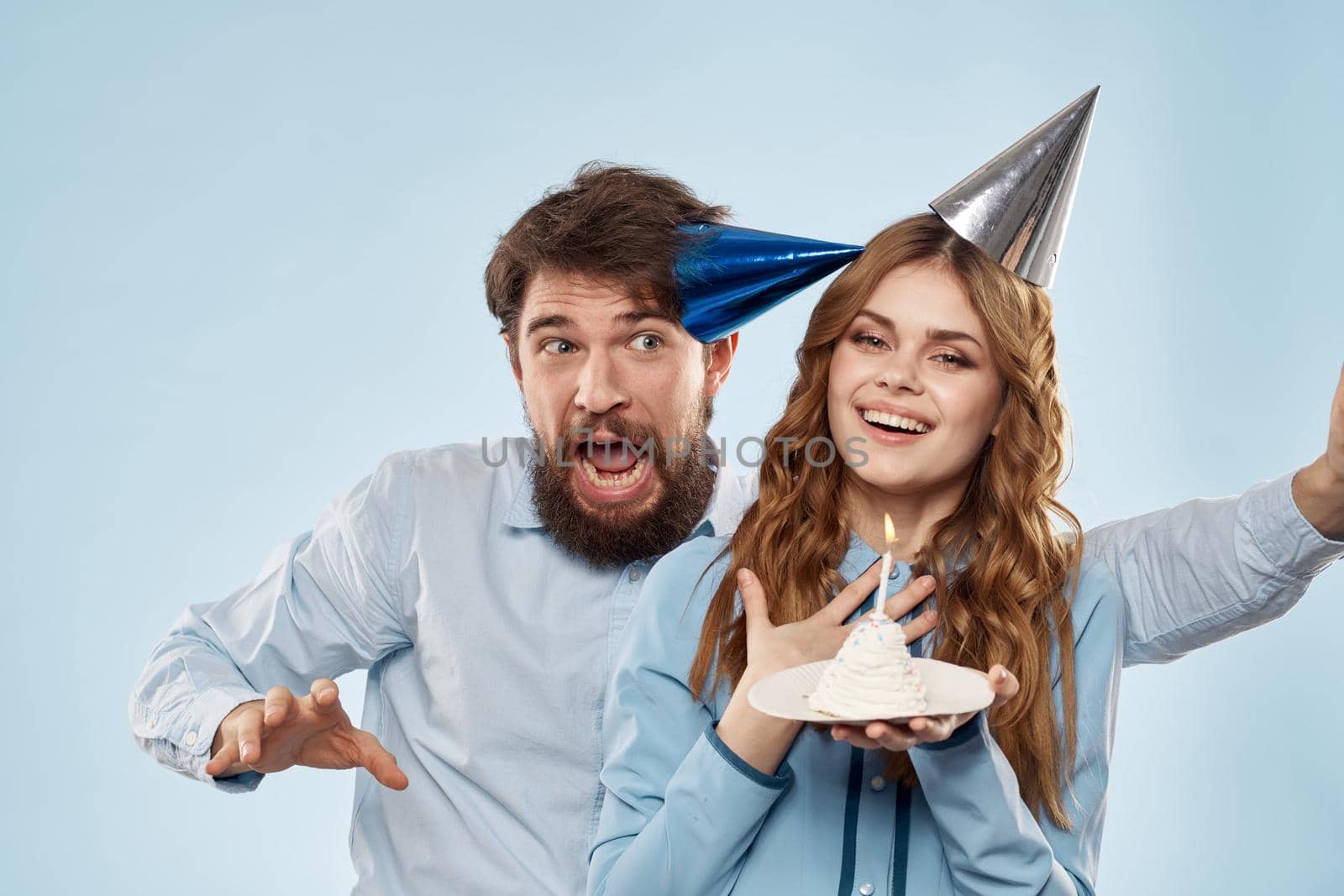 Birthday corporate young man and woman with cake on isolated background disco party. High quality photo