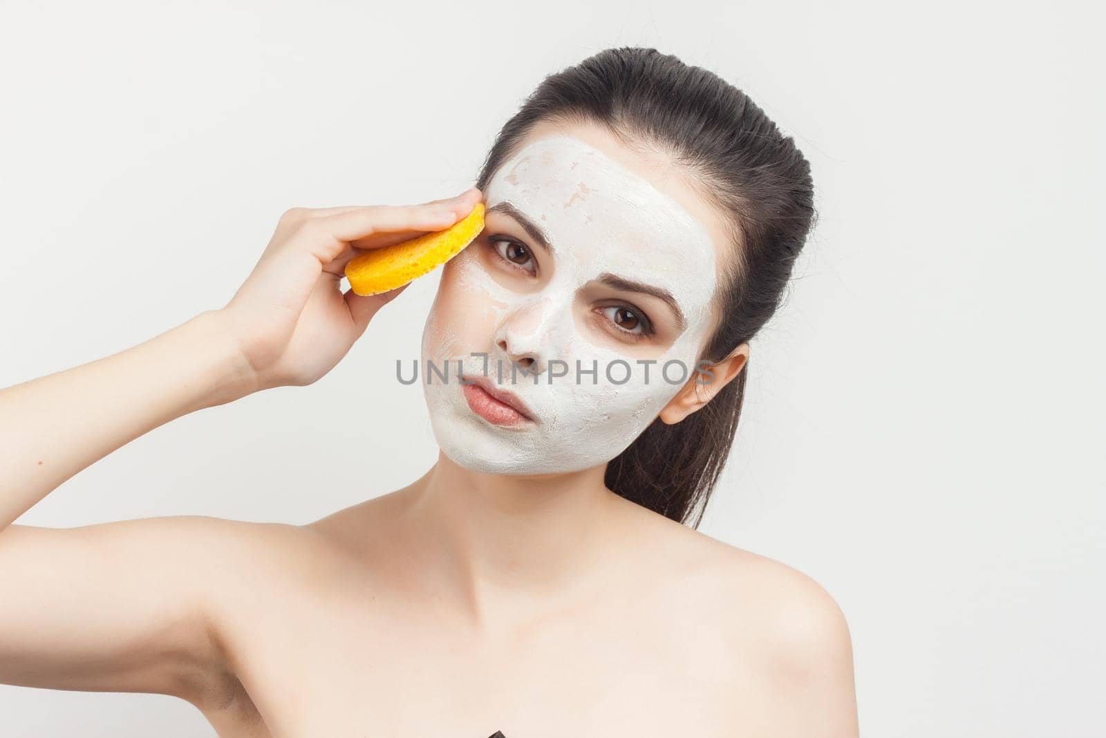 attractive brunette naked shoulders cosmetics skin care makeup. High quality photo