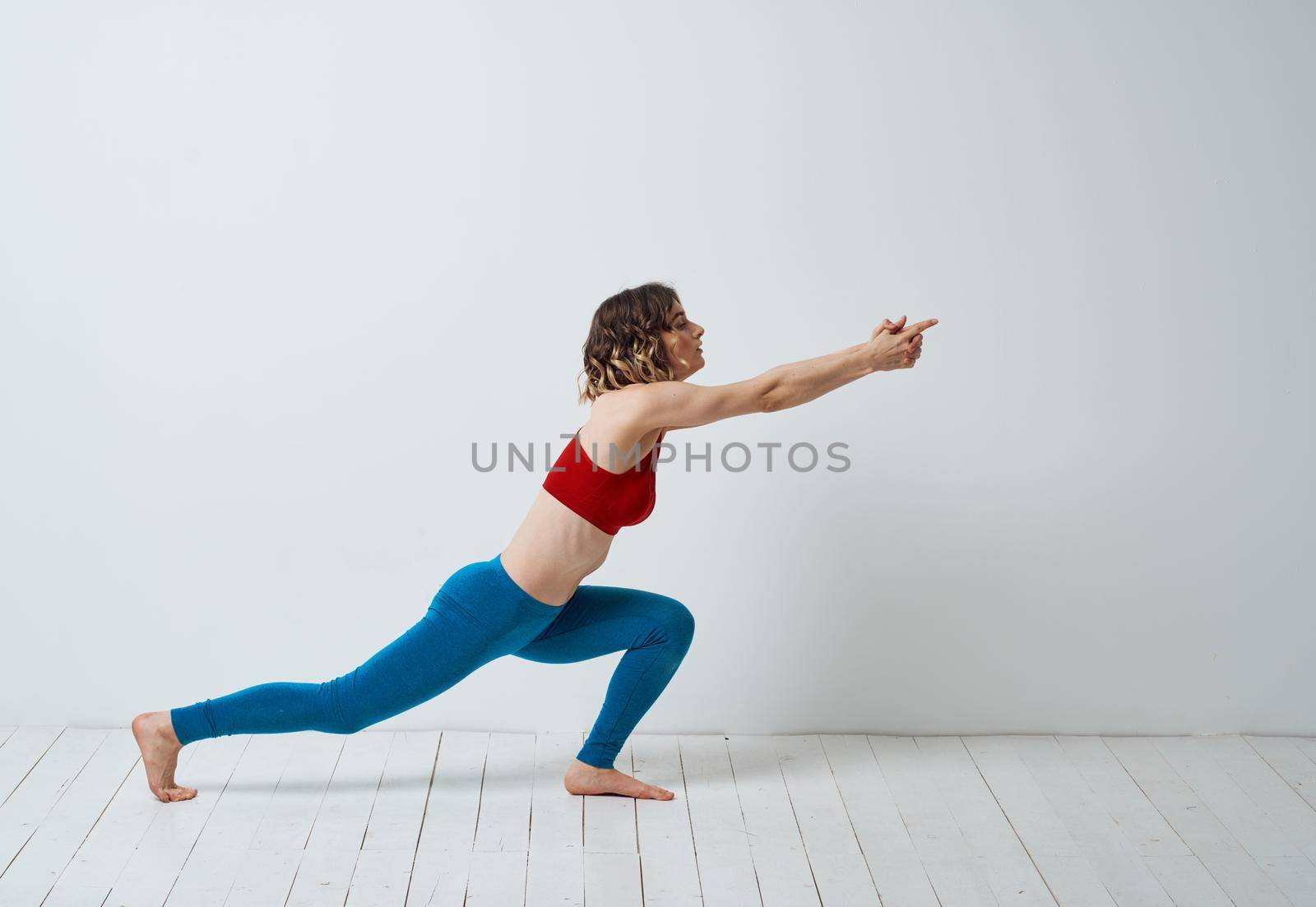 Woman doing gymnastics exercises yoga asana sportswear by SHOTPRIME