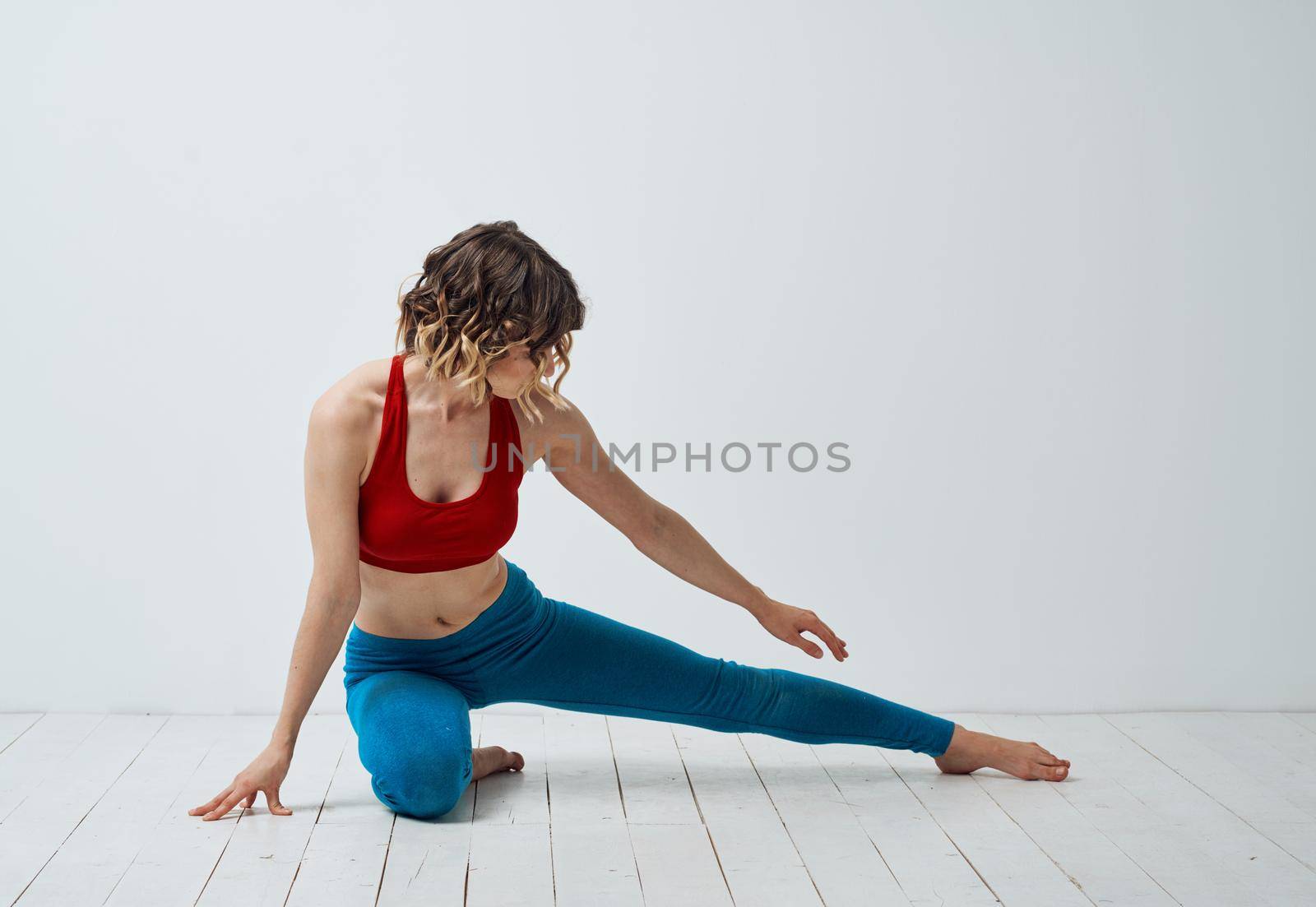 Sports woman yoga asana meditation in a light room gestures with her hands by SHOTPRIME