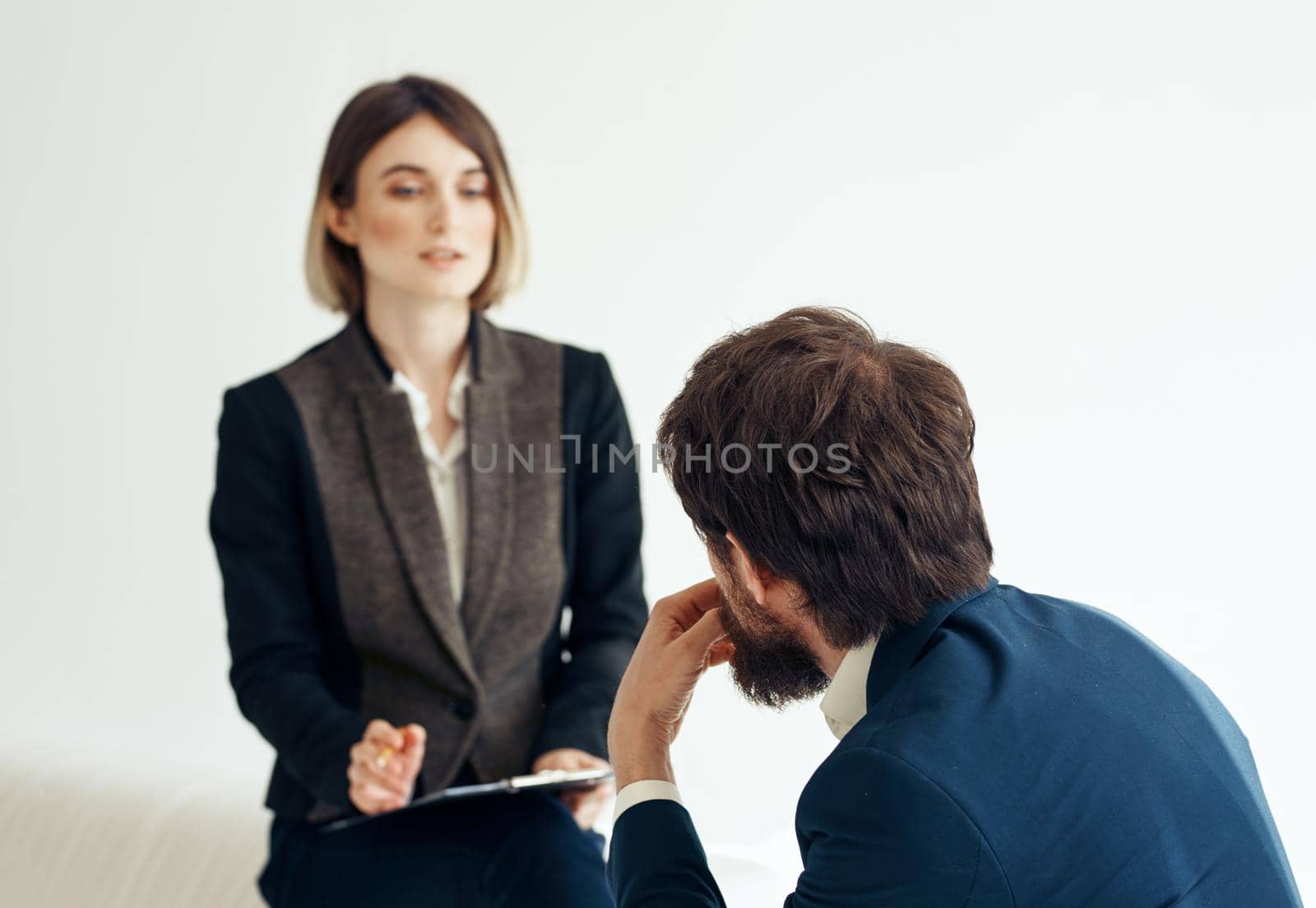 Woman and man in a jacket on a light background job interview. High quality photo