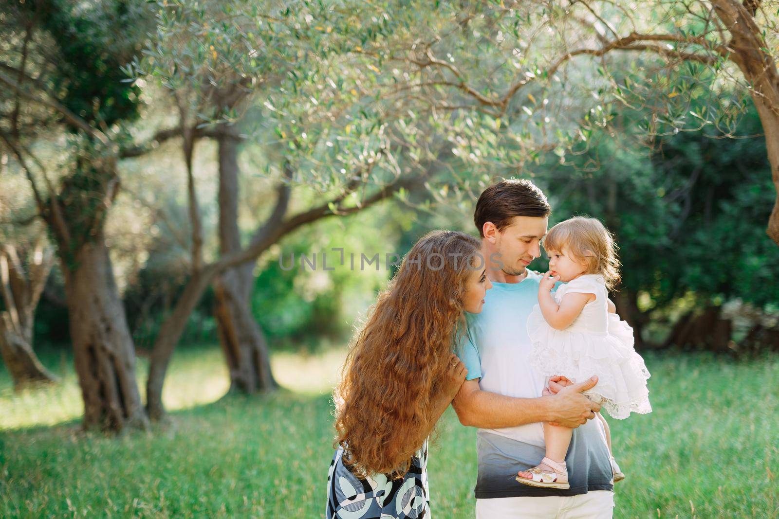 beautiful happy family in the olive grove in Montenegro. High quality photo