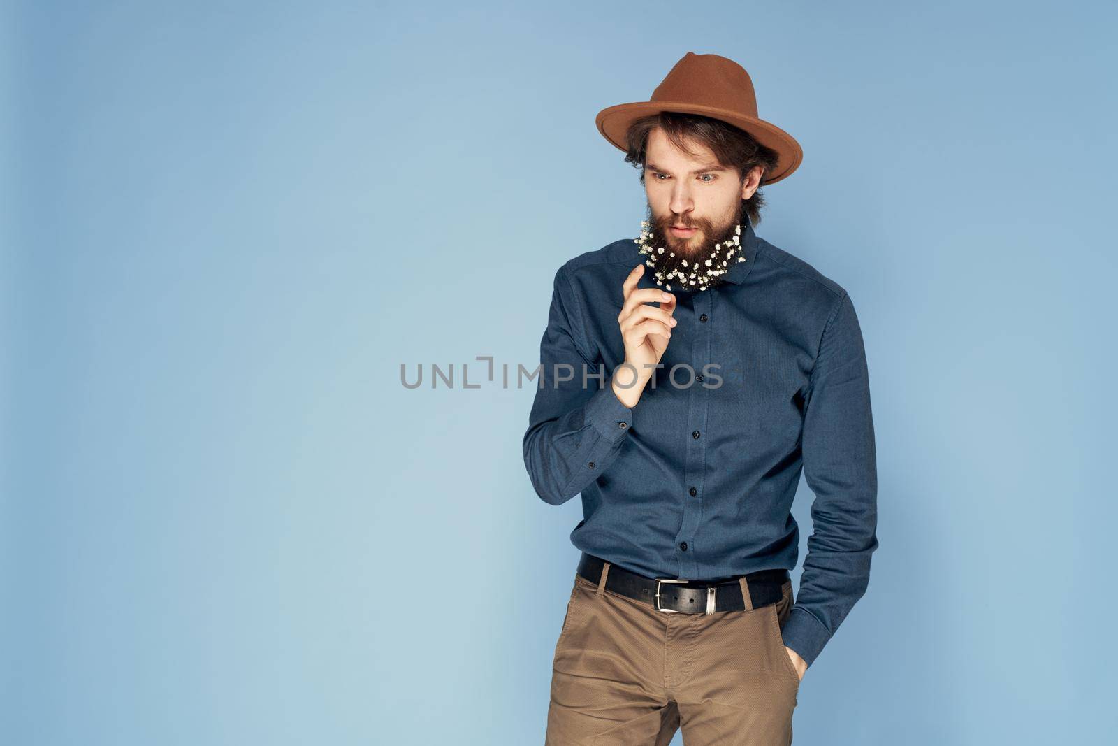 Man in hat emotions joy flowers Studio shirt fashionable clothes. High quality photo