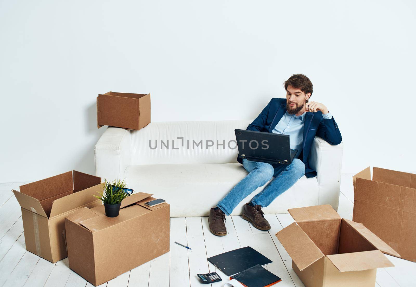 Man sitting on couch boxes with things new place of work office professional by SHOTPRIME